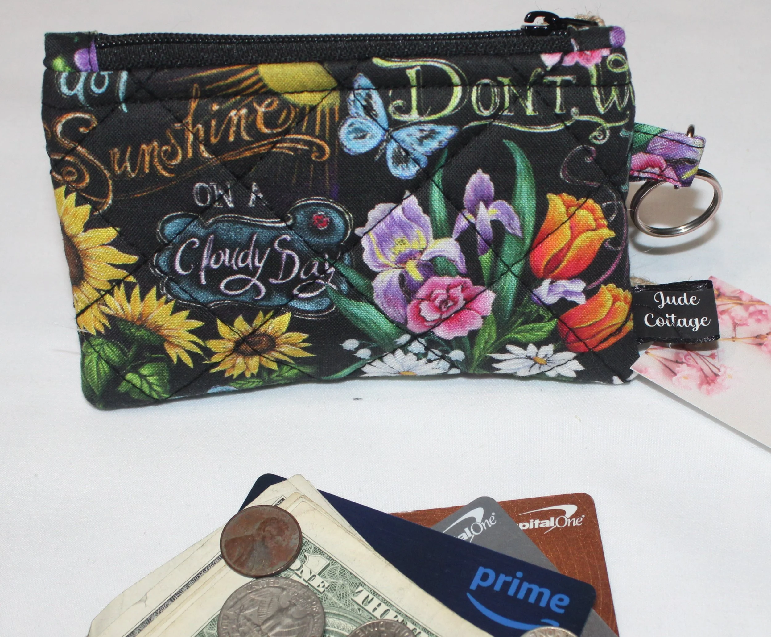 Quilted keychain wallet with You Are My Sunshine design, zipper closure, and metal key ring.