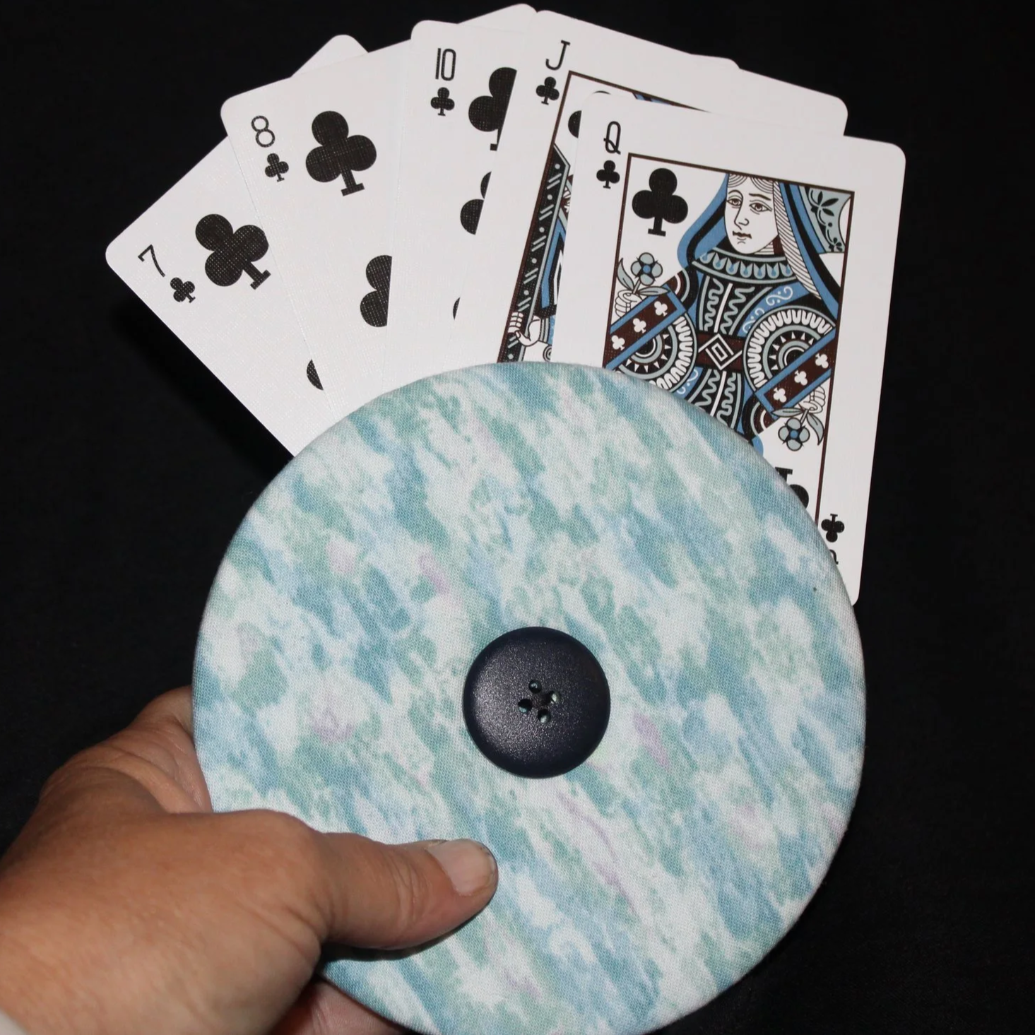 Front view of the Ocean Tide Card Holder featuring shades of blue, green, white, purple shown in use being held with an array of playing cards.
