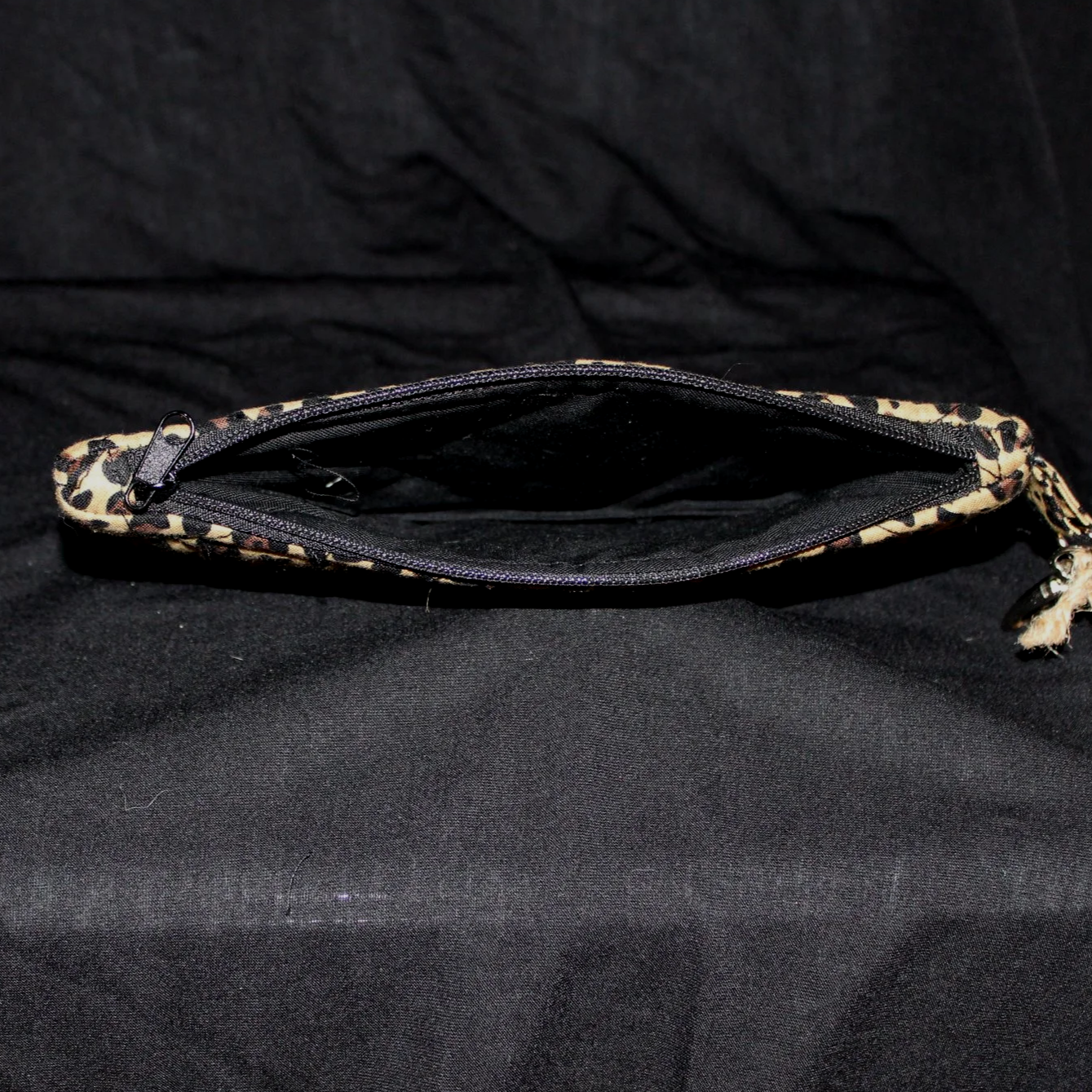 Top open view of the Sahara Large Keychain Wallet showing black zip closure and lining.