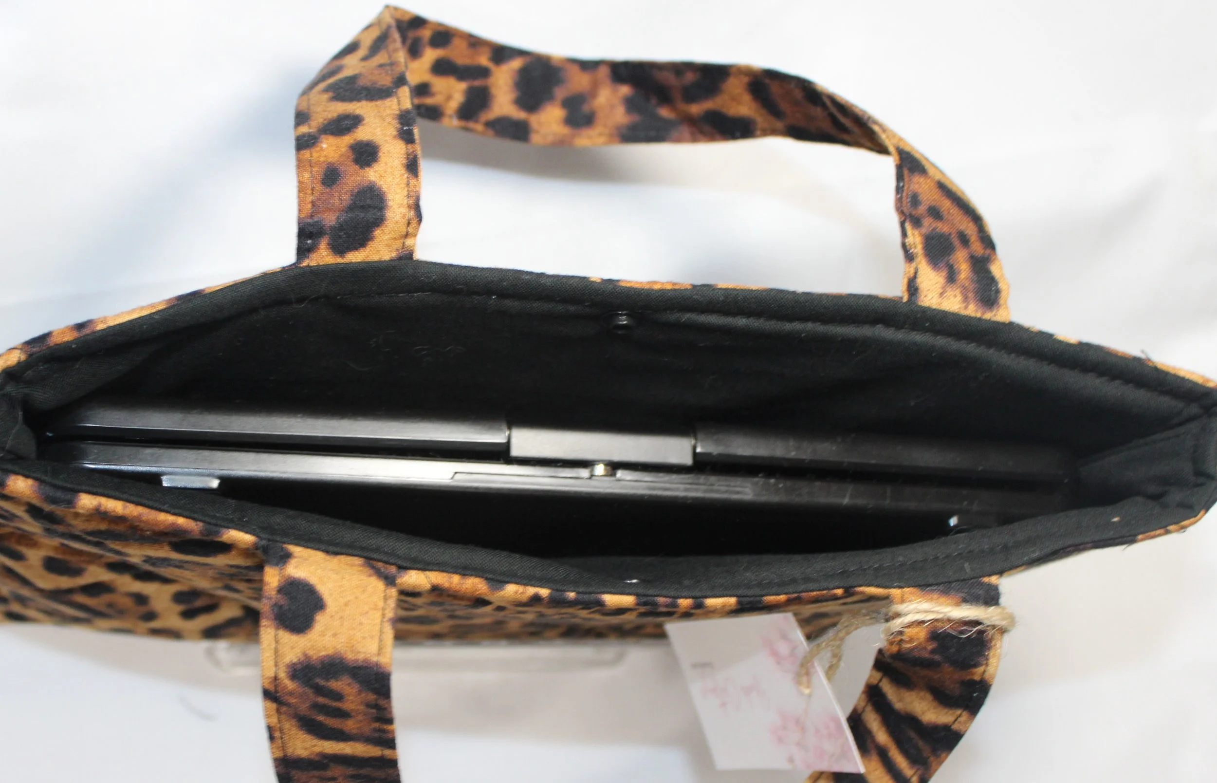 Top view of the Lyra quilted animal-print sleeve with jaguar print fabric, and a tablet inserted.