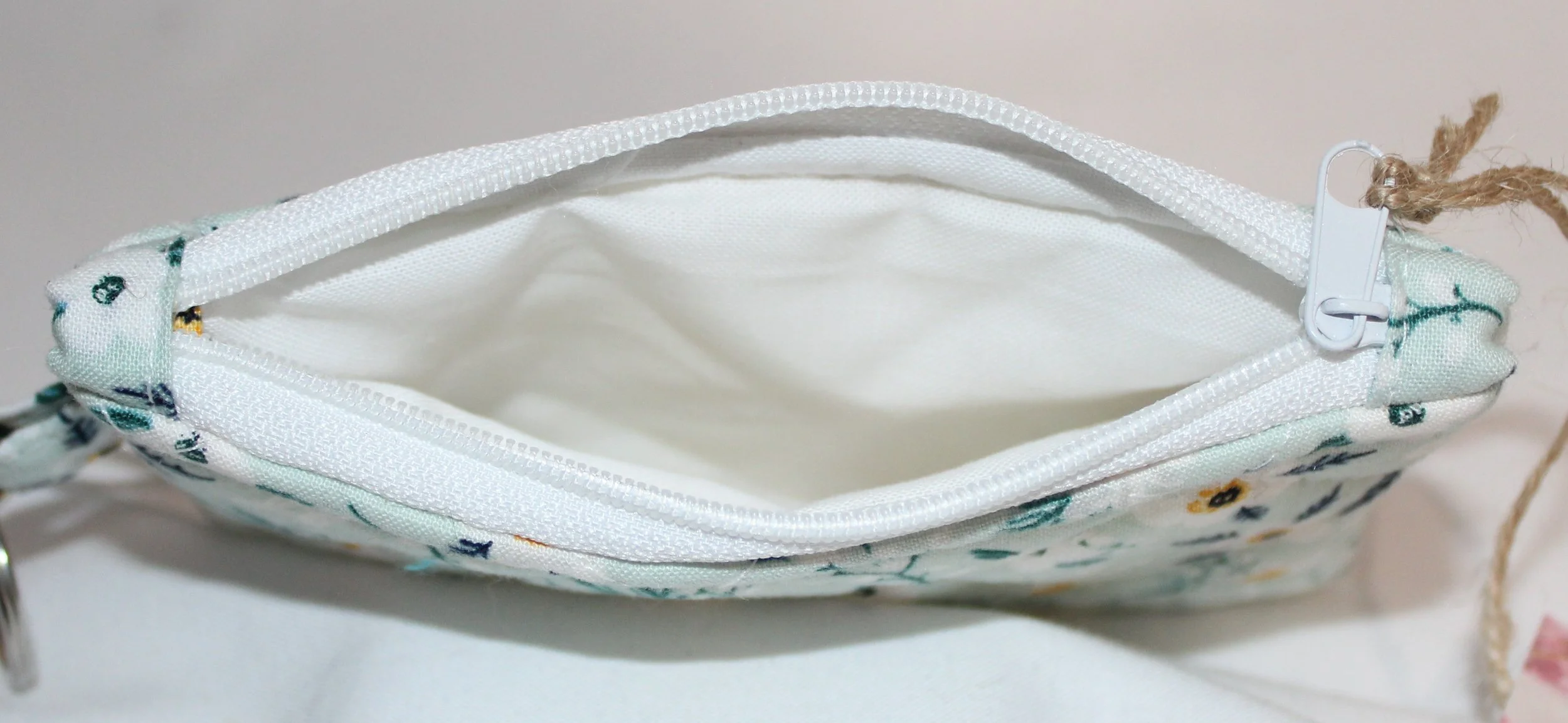 Top view quilted keychain wallet with Vera pattern, zipper closure, and metal key ring.