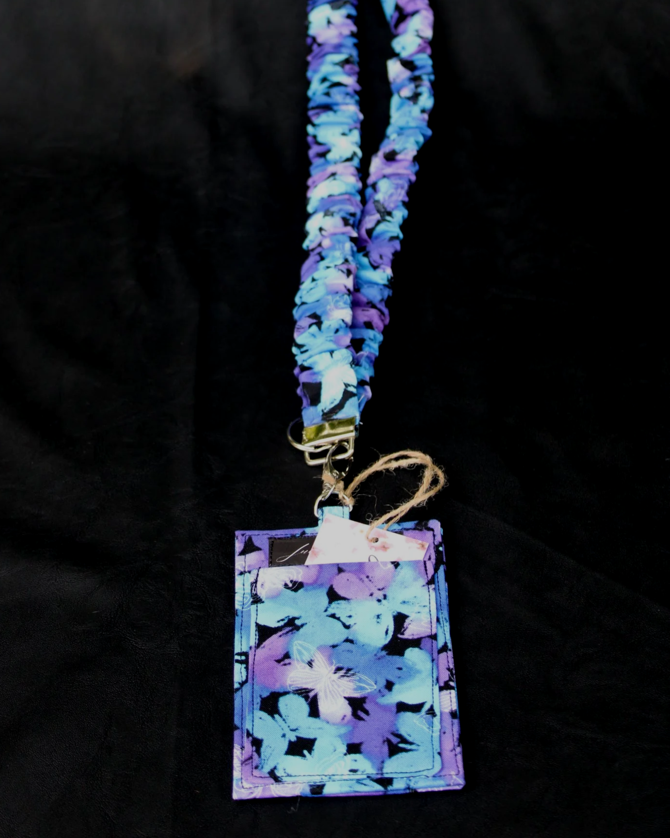 Back view of the Butterfly Mist Lanyard with badge holder shown with a card slipped into the pocket.