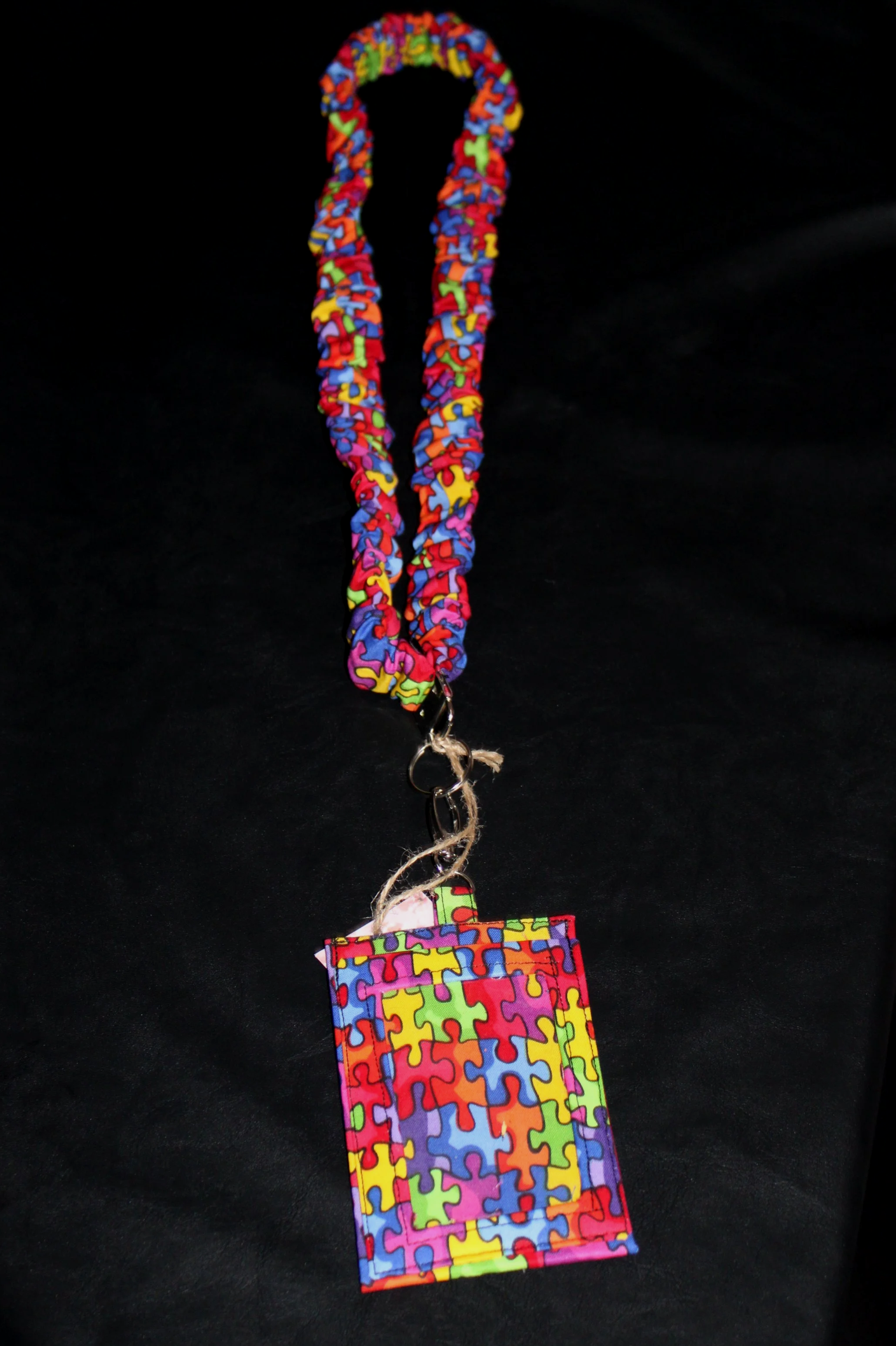 View of the Autism Scrunch Lanyard and Badge Holder featuring Autism awareness print fabric.
