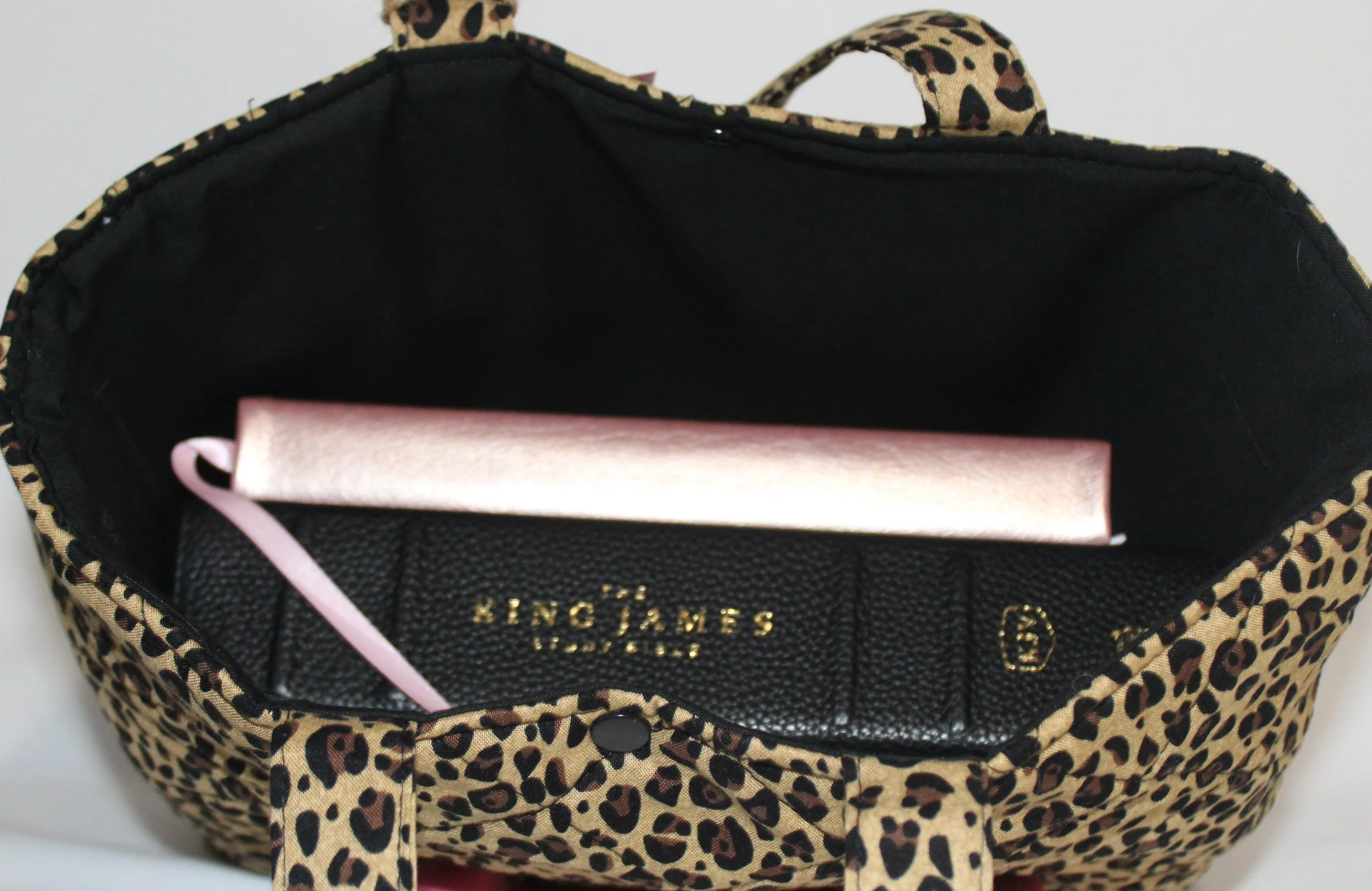 Top view of the Sahara quilted Bible sleeve with a study Bible and notebook inserted to show sizing and use.