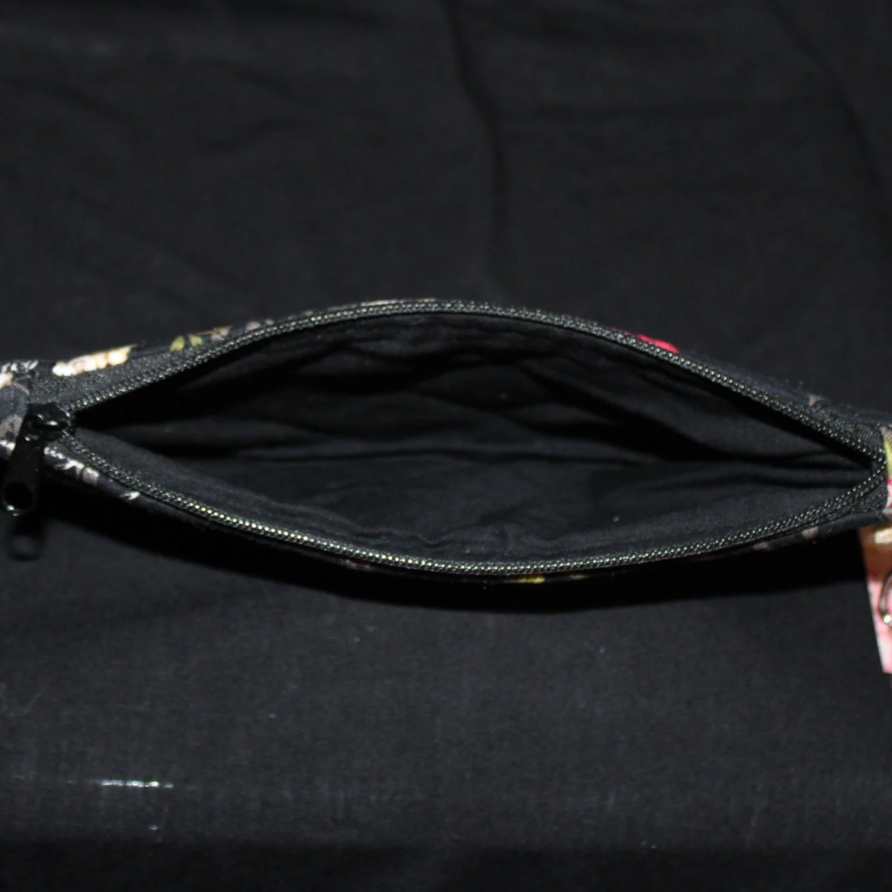 Top open view of the Amazing Grace Large Keychain Wallet showing black zip enclosure and black lining.