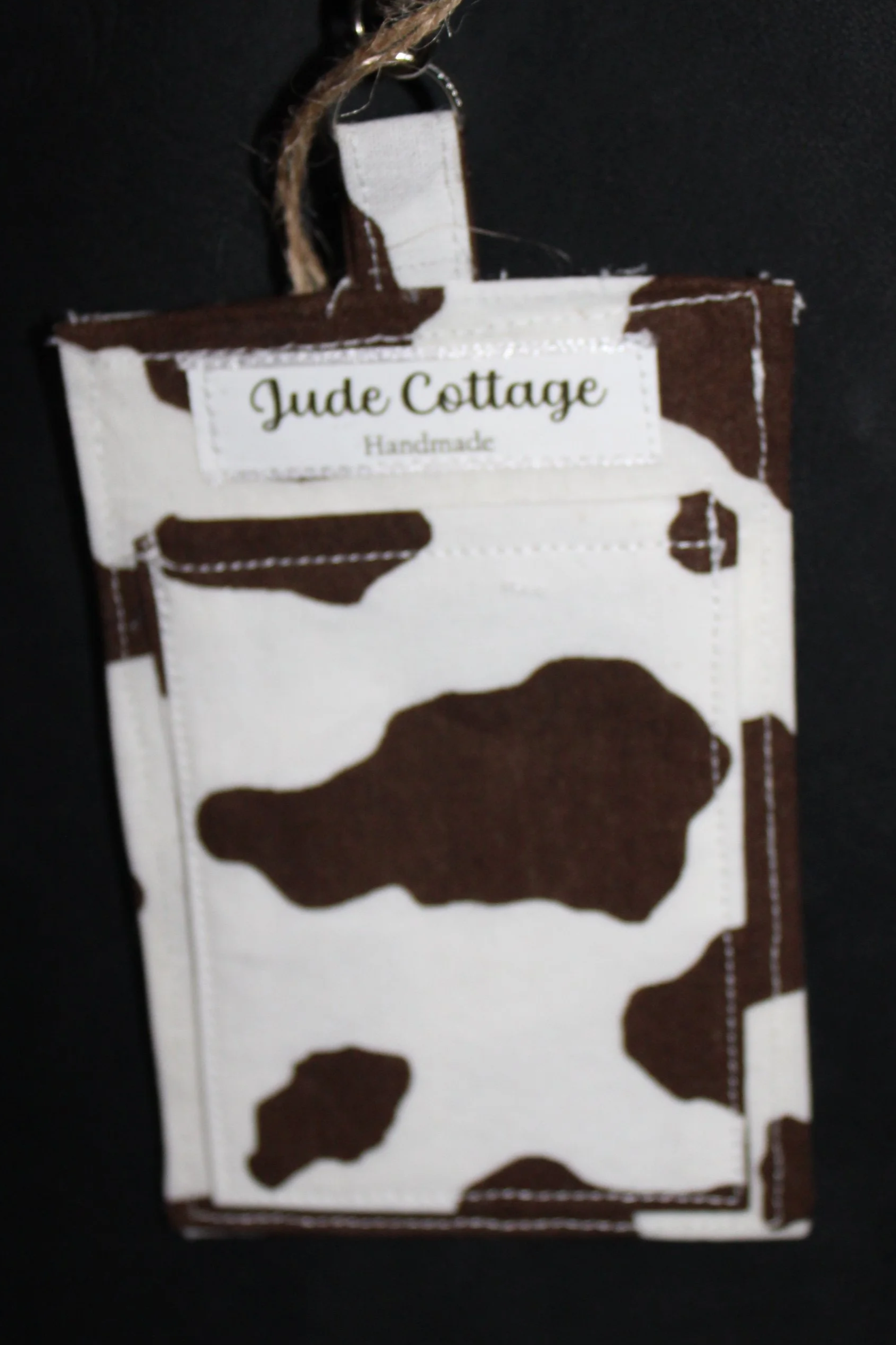 Empty back view of the Brown Cow Badge Holder featuring a slip pocket for cash, cards, or other essentials.