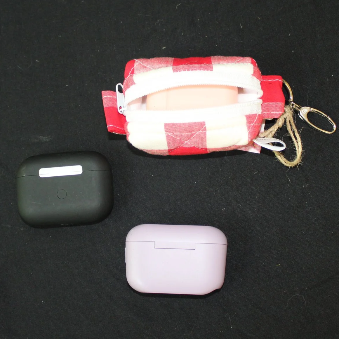 Open top view of the Stella Bag shown with an Airpod case inserted for sizing demonstration.