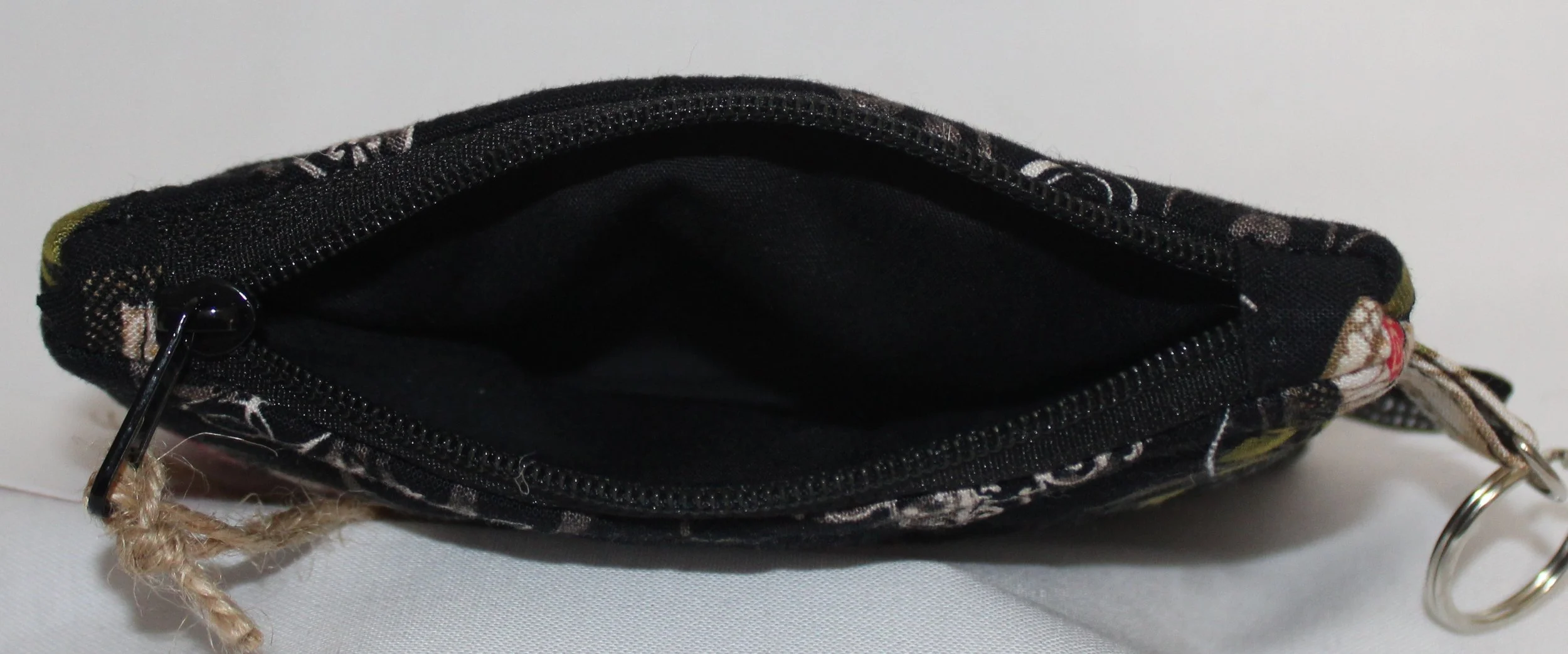 Top view quilted keychain wallet with Amazing Grace inspirational pattern, zipper closure, and metal key ring.