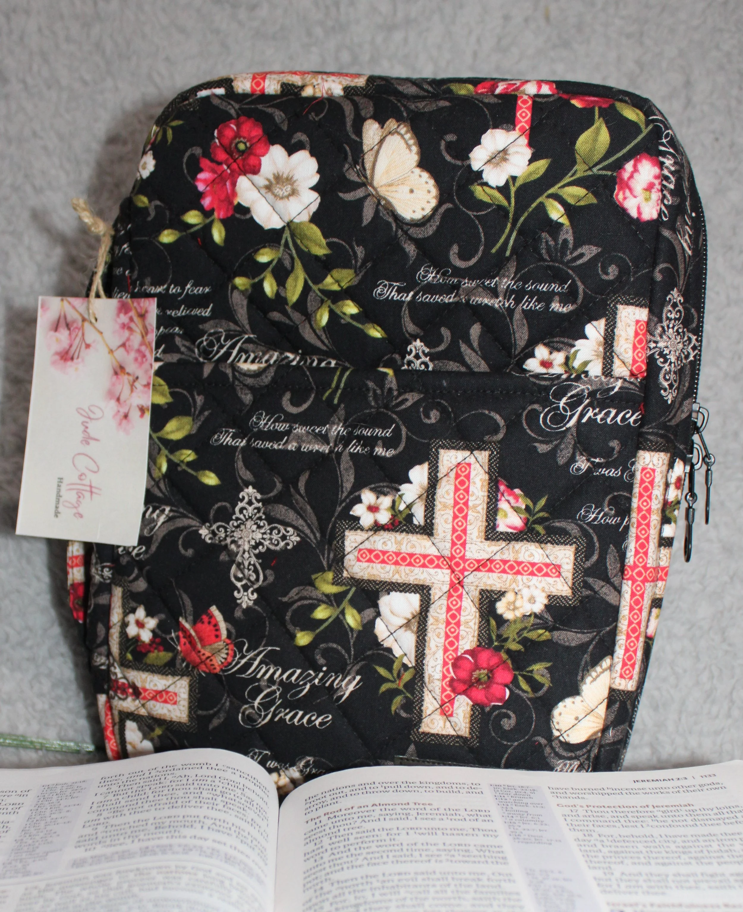Front view of Amazing Grace bible case with red and white flowers, cross motifs, and printed hymn wording.
