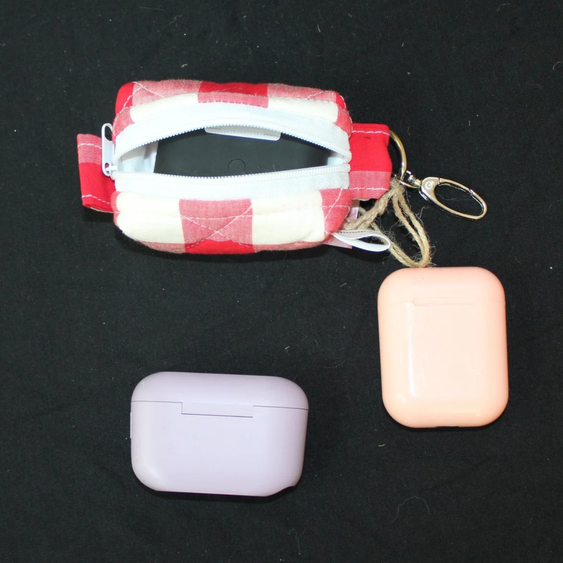 Open top view of the Stella Bag shown with an Airpod Pro case inserted for sizing demonstration.