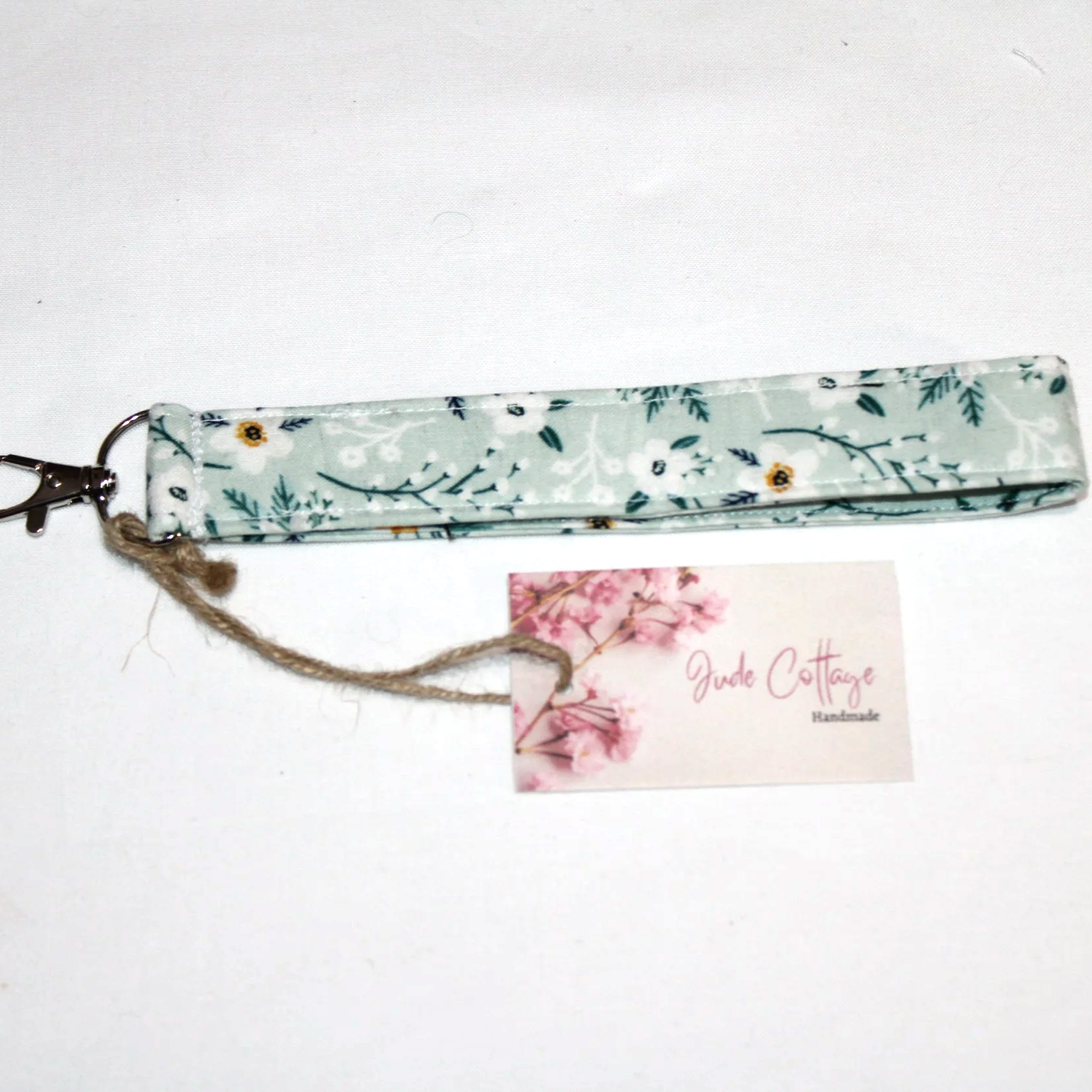Close-up of the Vera Wristlet featuring light blue background with white floral print.