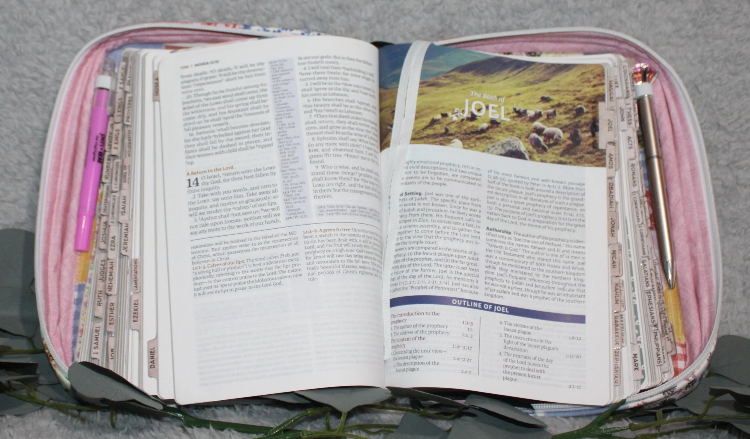 An open view of the case with a bible inside interior ribbons and pens in the included holders.