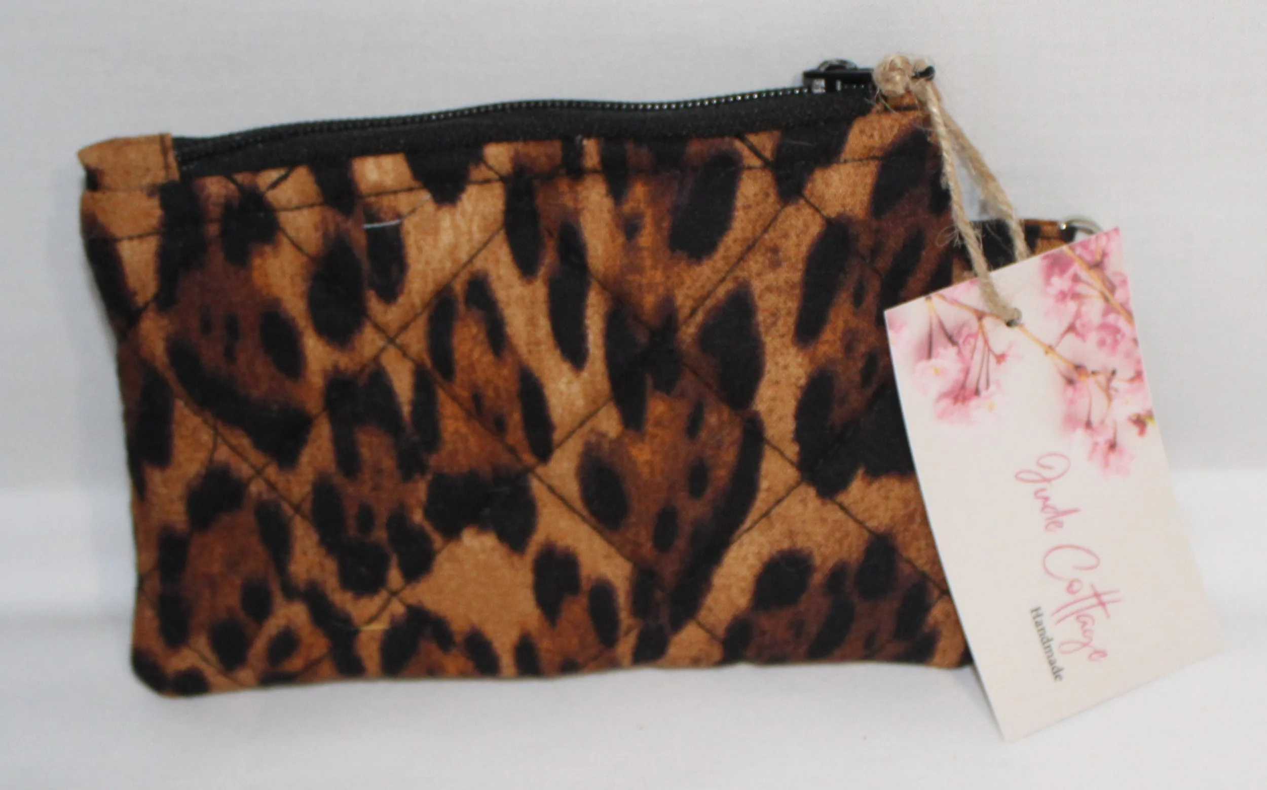 Quilted keychain wallet with Lyra leopard pattern, zipper closure, and metal key ring.