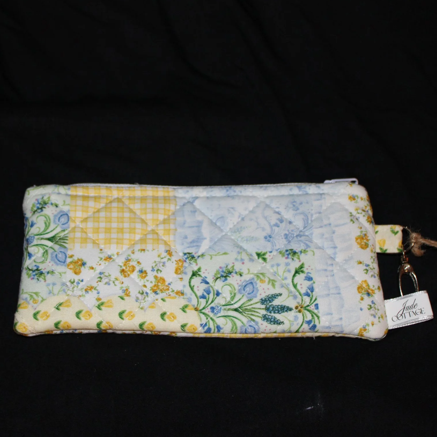 Front view of the Annalee Large Keychain wallet featuring yellow, green, blue, and white patchwork fabric.