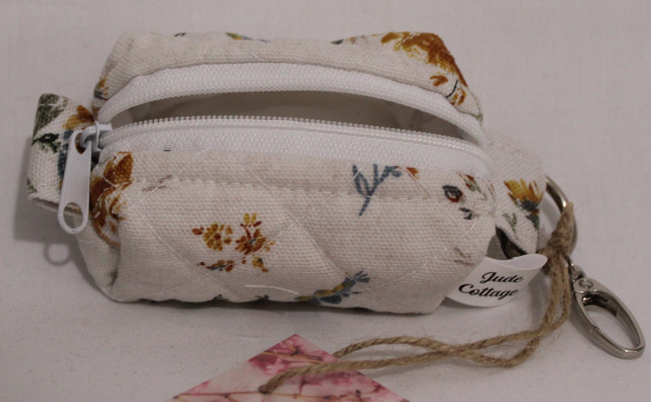 Top open view of the Dandelion Blue Bag Charm featuring assorted dandelions on an off white background and showing white lining.