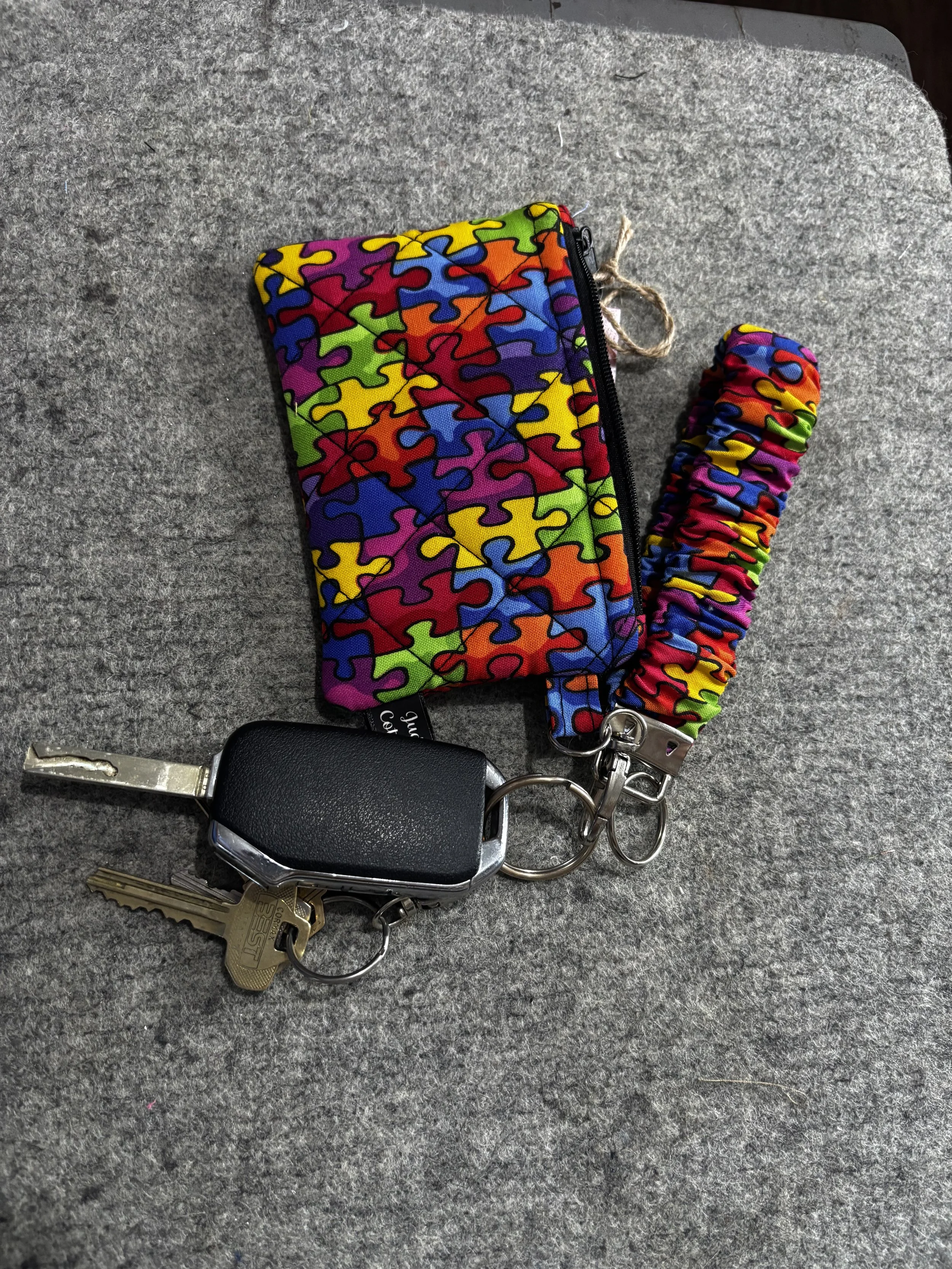 Autism Awareness Wallet Set shown clipped to a keyring to demonstrate use.