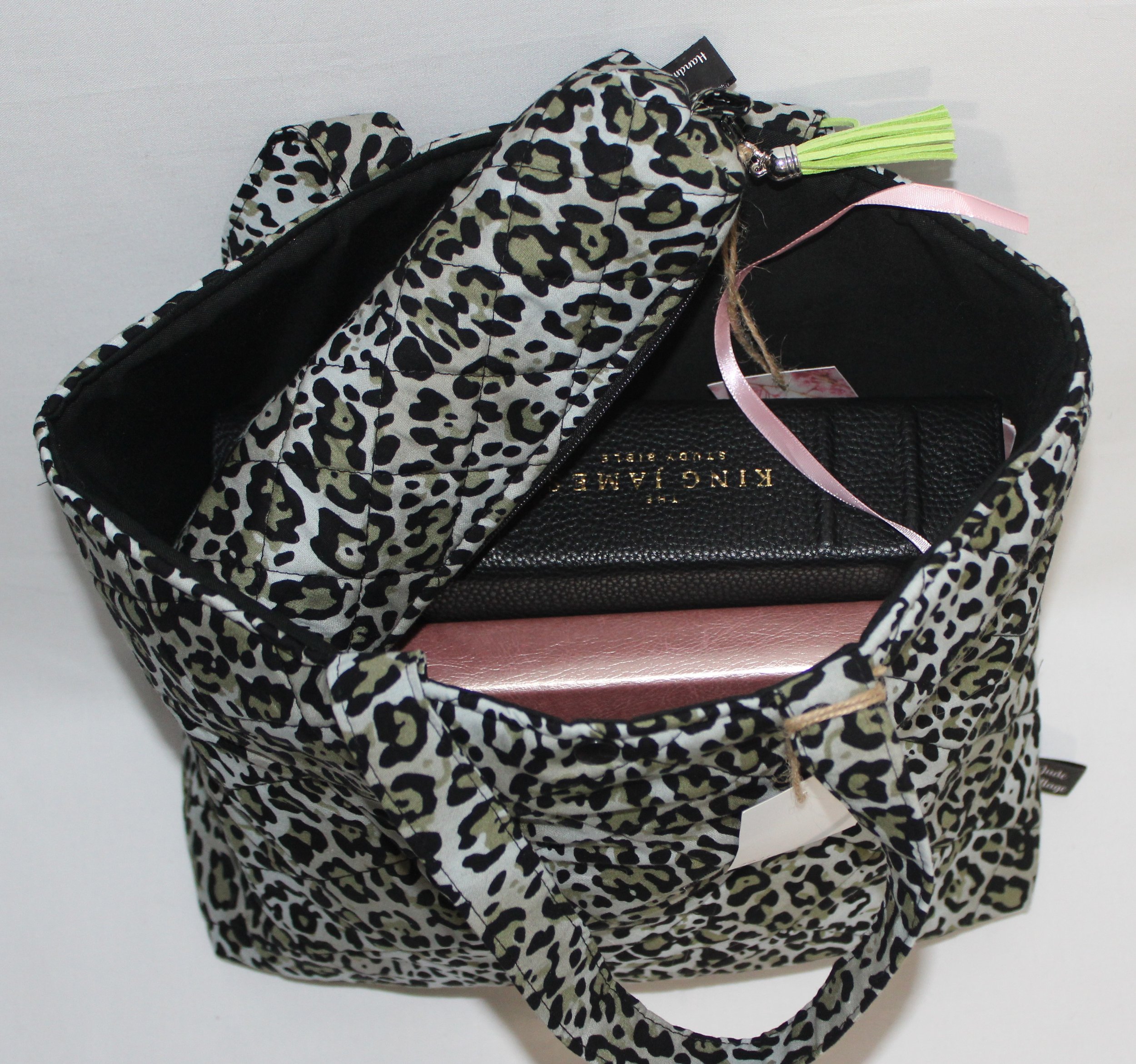 Top view of the Diana quilted Bible sleeve with a study Bible, notebook, and pencil pouch inserted to show size and use.