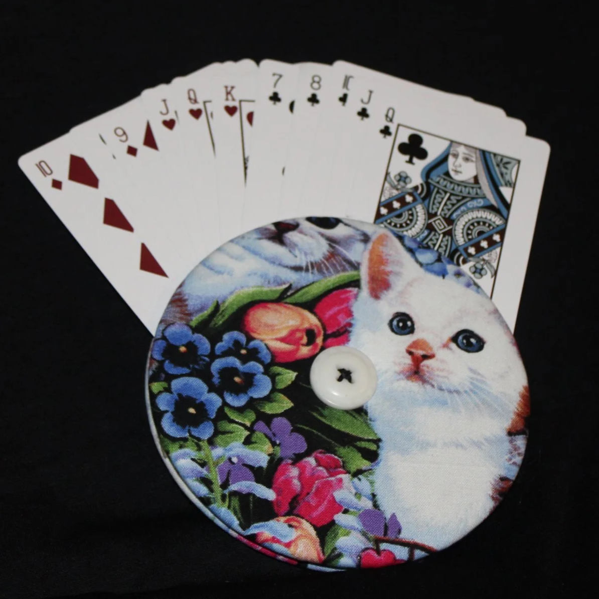 Front view of the Kitty Love Card Holder featuring an assortment of cats and floral accents shown in use with an assortment of playing cards.