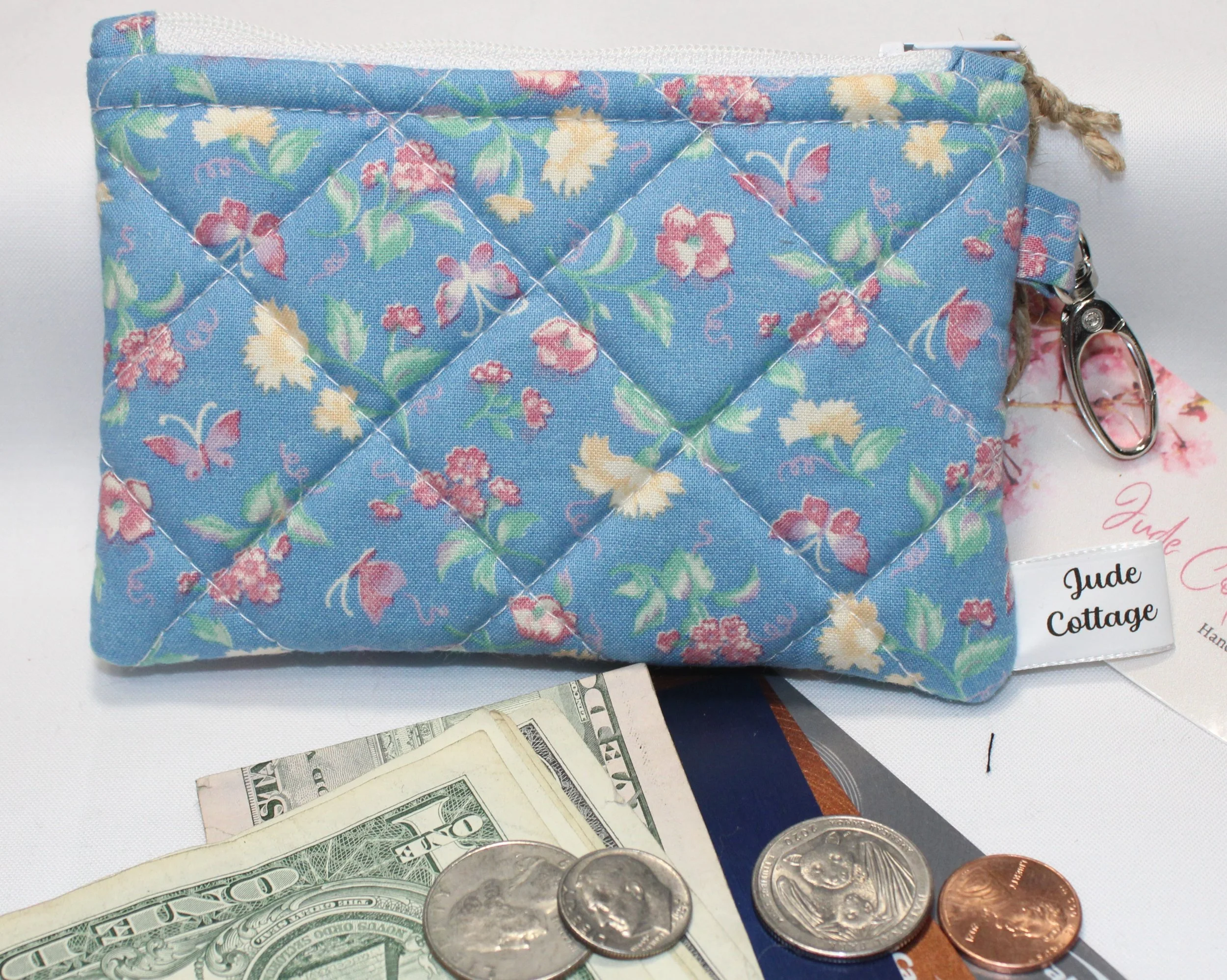 Quilted keychain wallet with Iola pattern, zipper closure, and metal key ring.