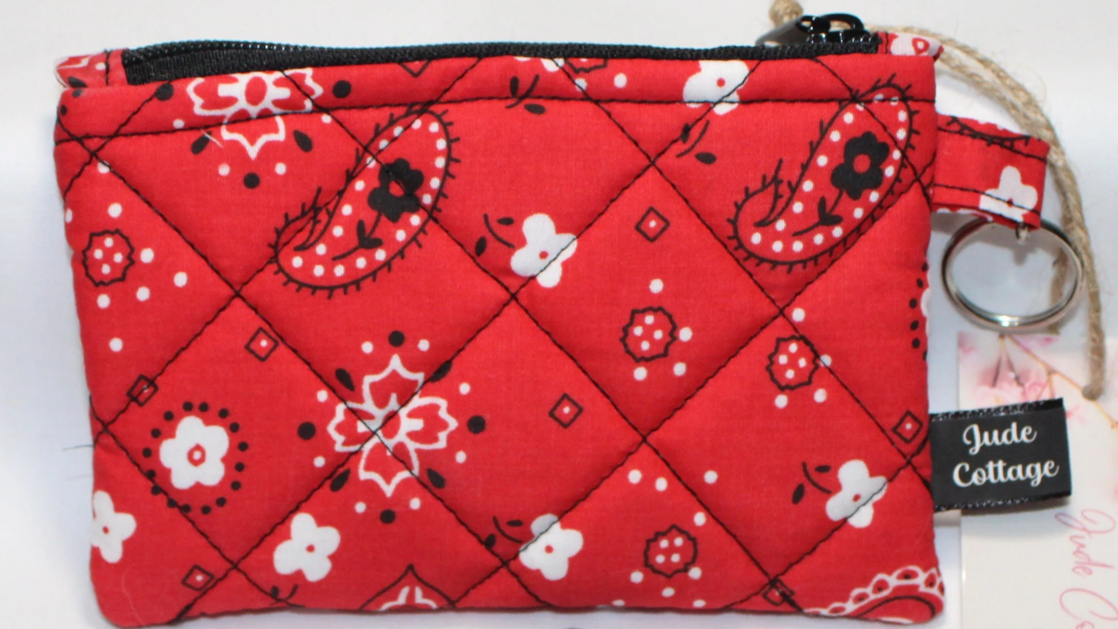 Red bandana-pattern quilted keychain wallet with zipper closure and metal key ring.