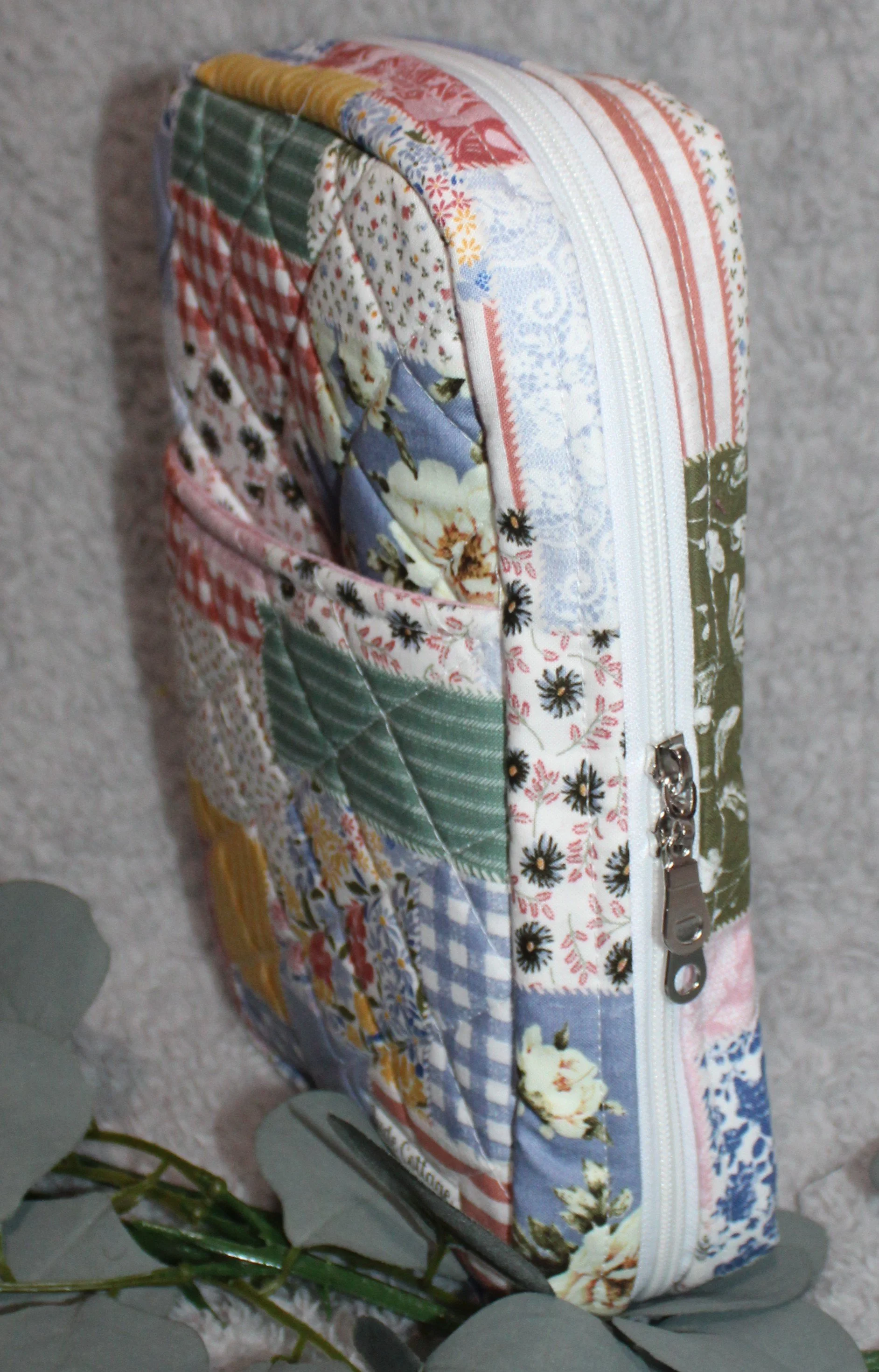 Close-up of the double zipper and variety of colorful patchwork fabric.