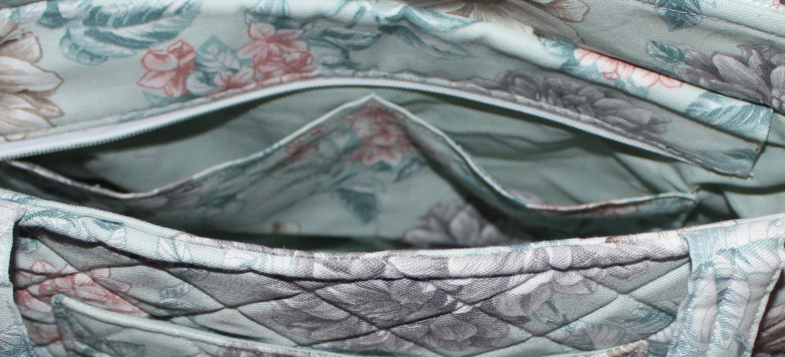 Interior view of the Joelle quilted tote showing the two slip pockets and the folded down recessed zipper.
