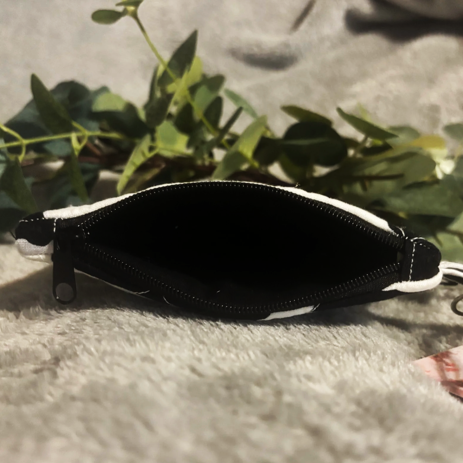 Top open view of the Black Cow keychain wallet showing black interior lining.