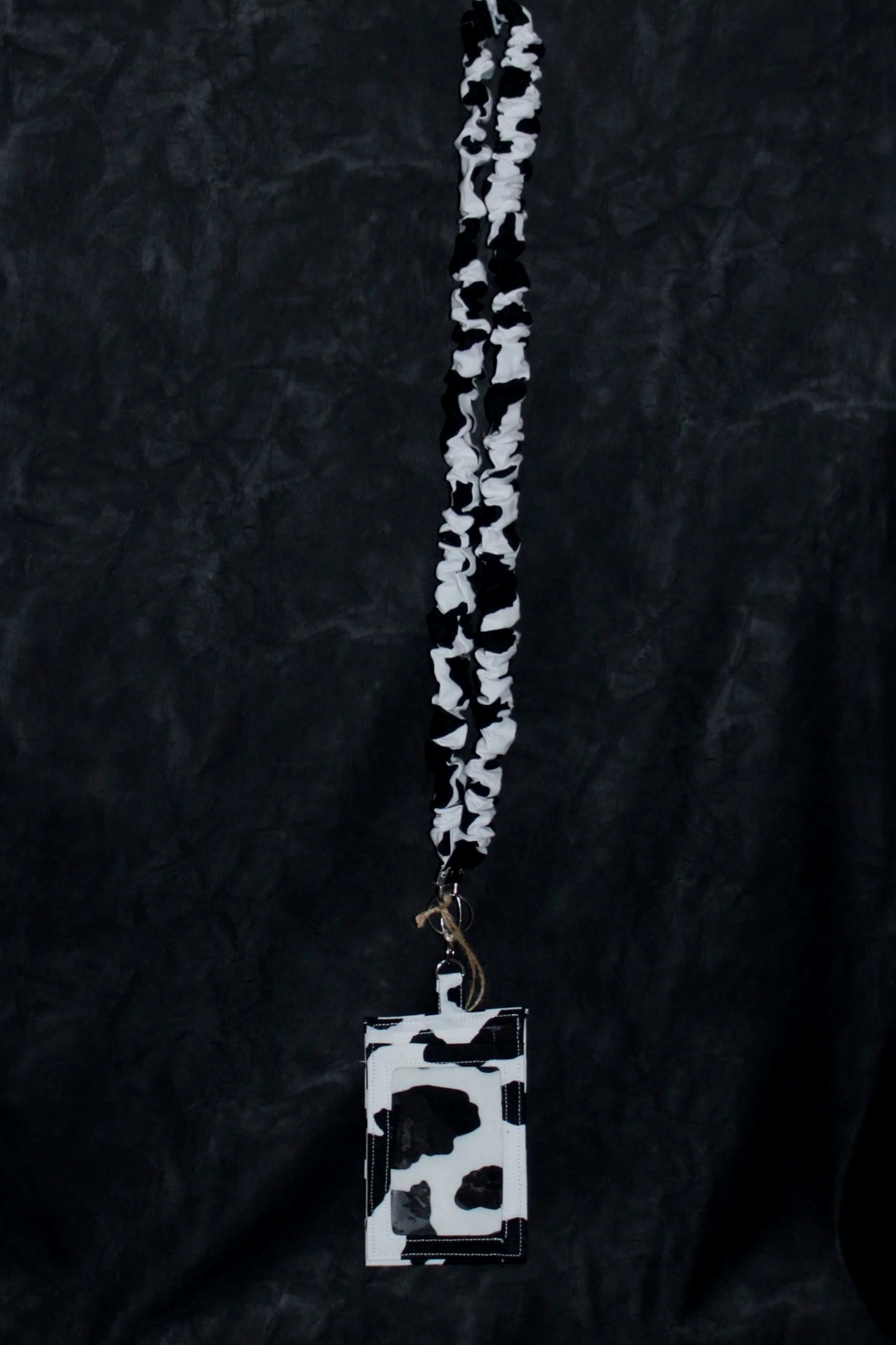 Hanging view of the Black Cow Scrunch Lanyard with Badge Holder.