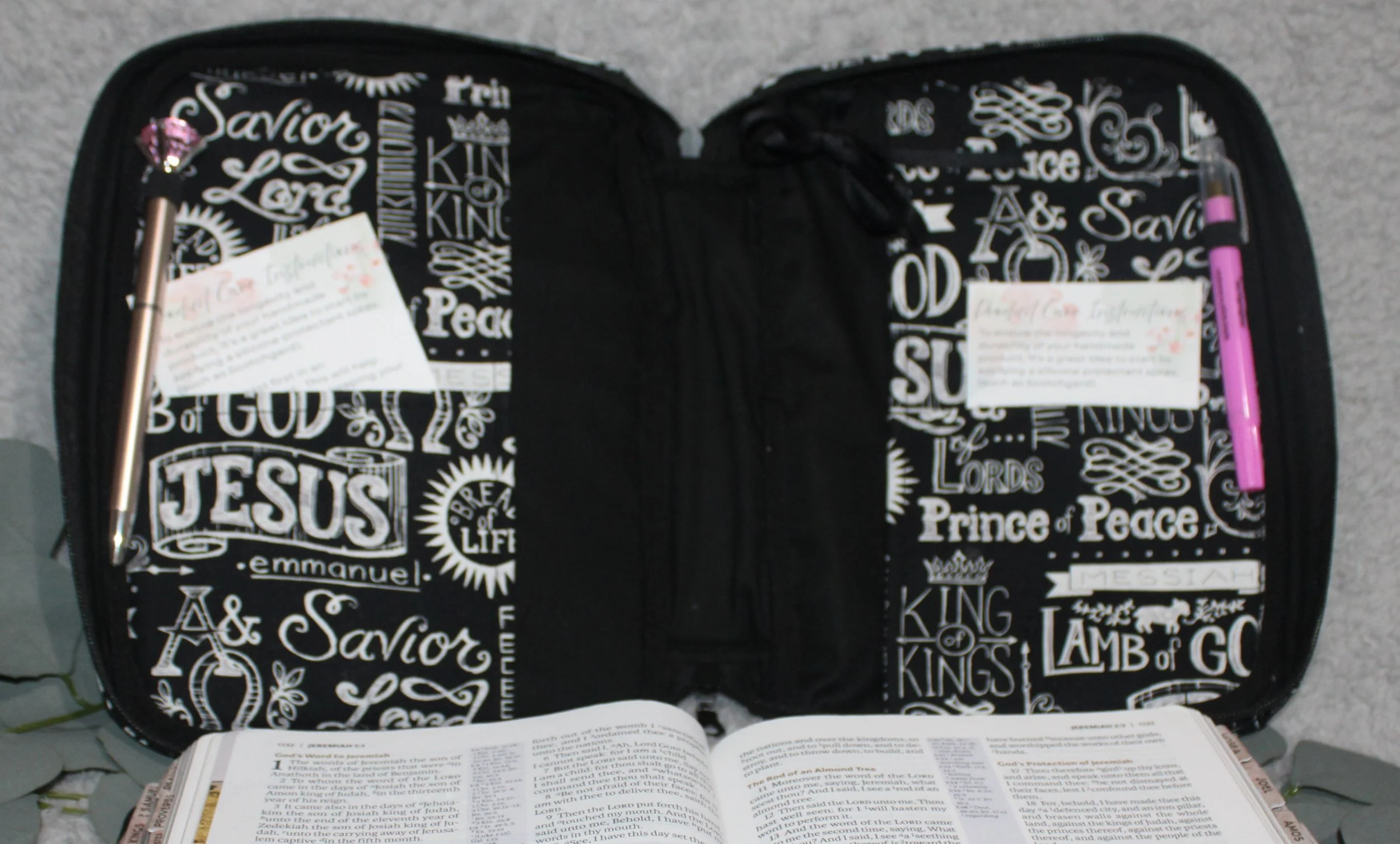 Empty interior view of the black and white ‘King of Kings’ Bible case showing the slip pockets and pen holders.