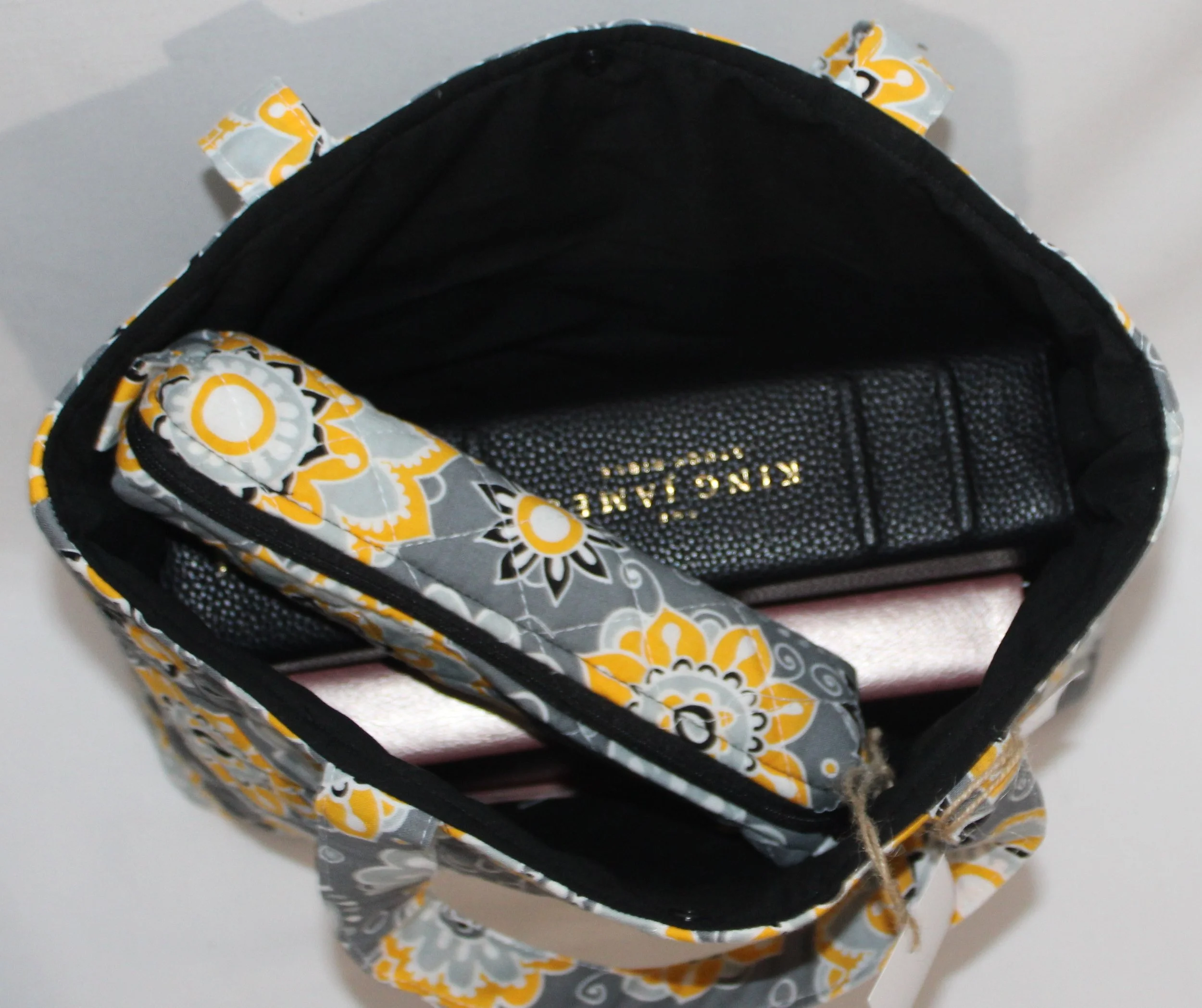 Interior view of the Medallion quilted Bible sleeve with a study Bible, notebook, and pencil pouch inserted to show sizing and use.