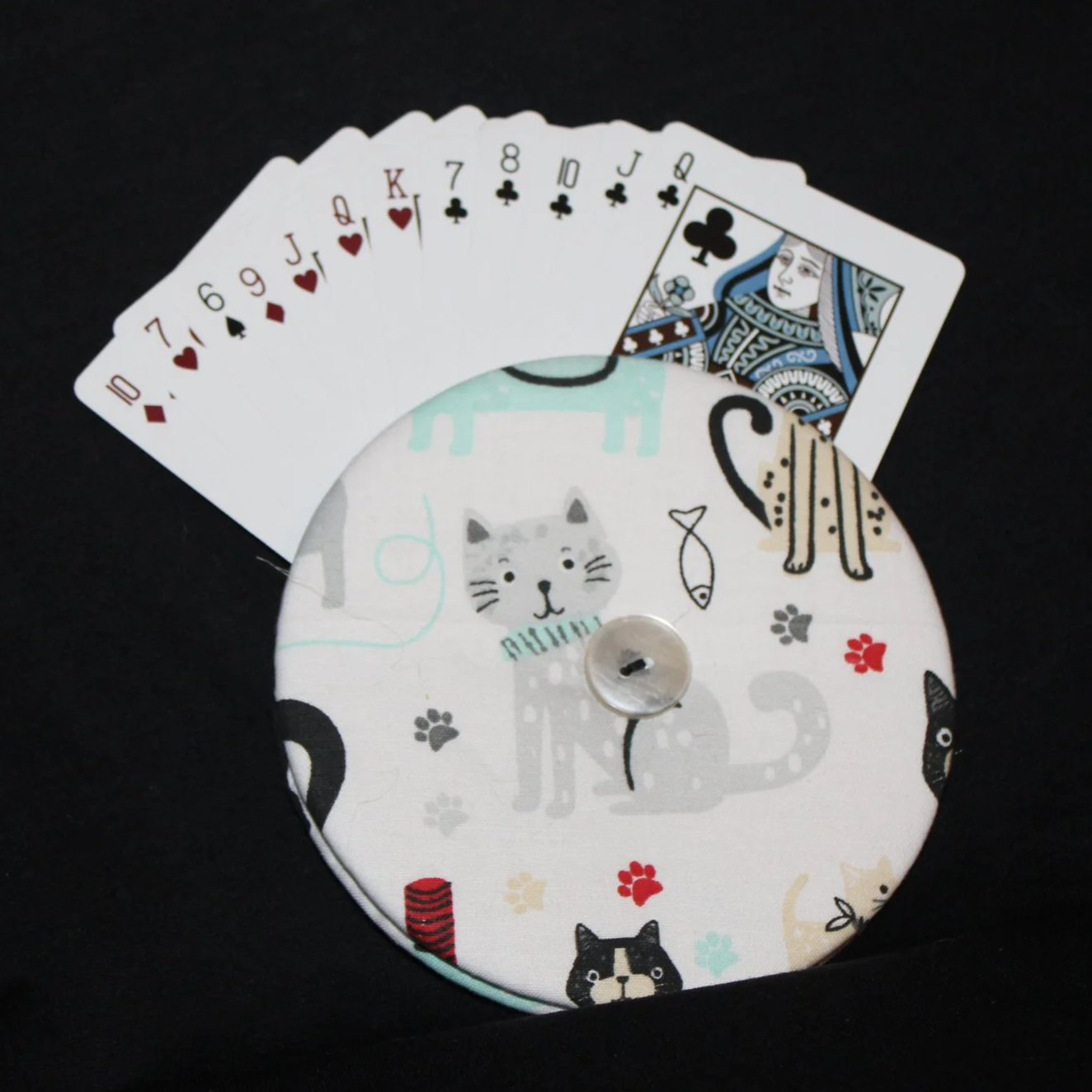 Front view of the Kitty Days Card Holder featuring an assortment of cats and floral accents shown in use with an assortment of playing cards.
