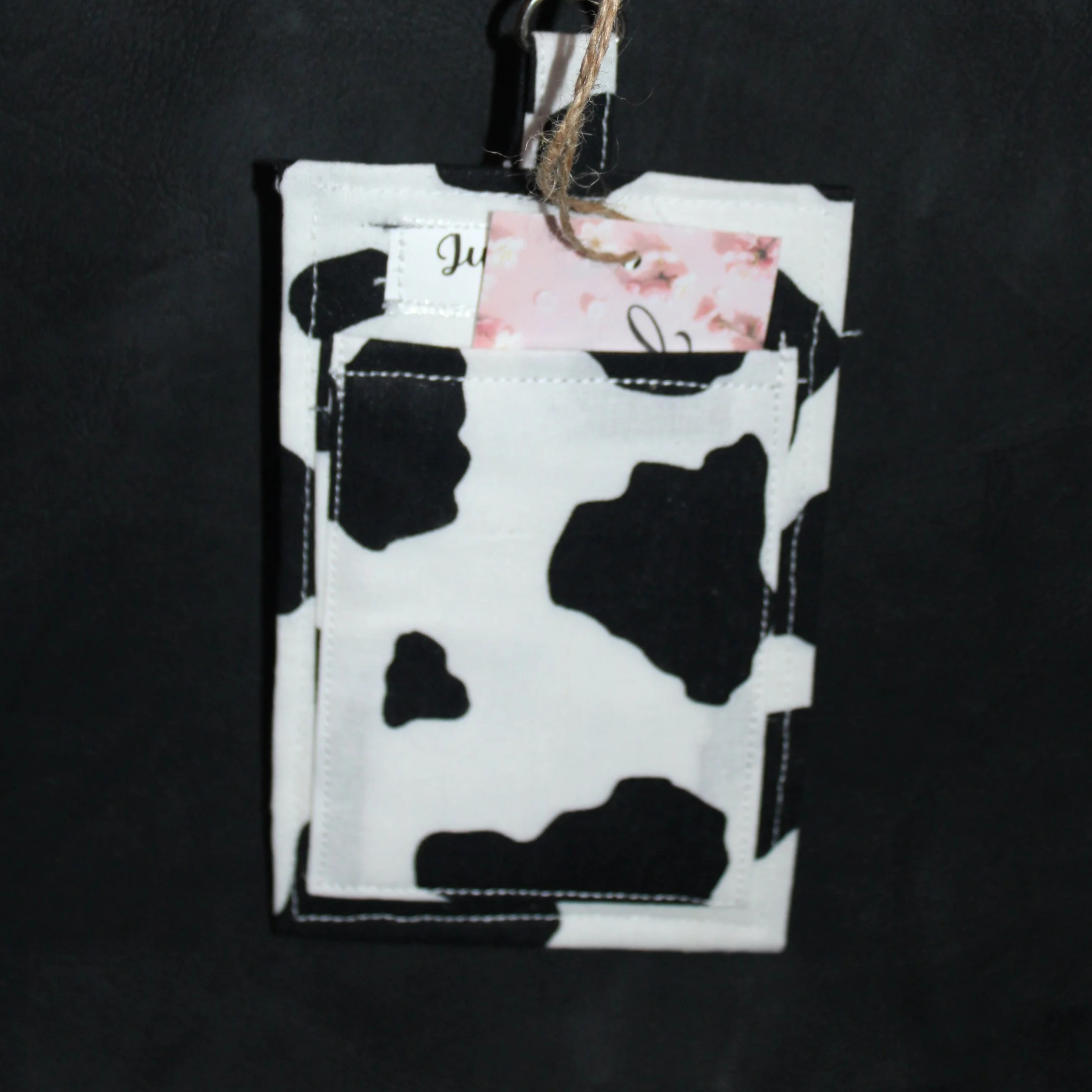 Back view of the Black Cow Badge Holder shown with card partially inserted to illustrate pocket.