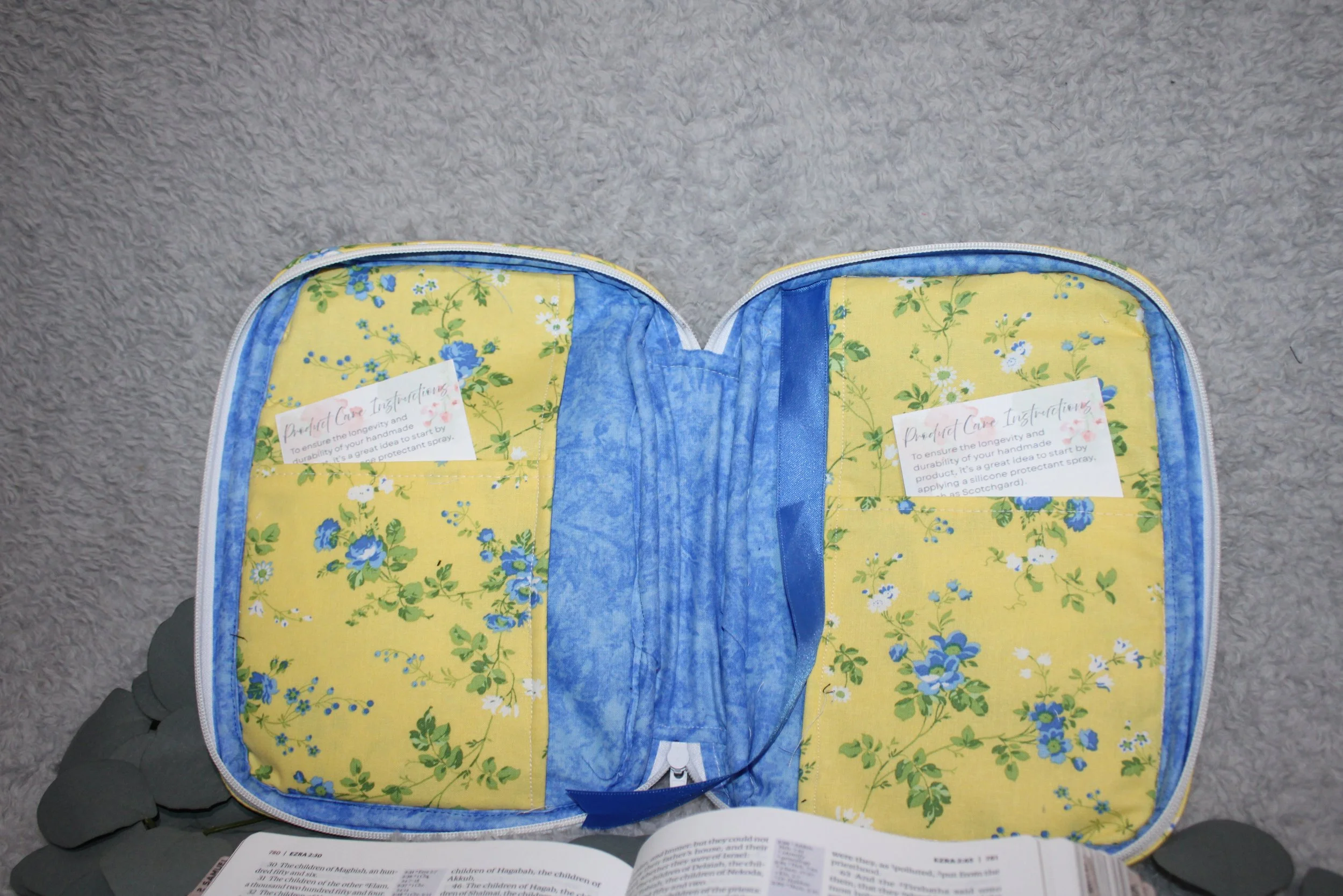 Empty interior view of the Flora Quilted Bible Study Case, showing the floral lining, interior slip pockets, and pen holders with the case fully open.