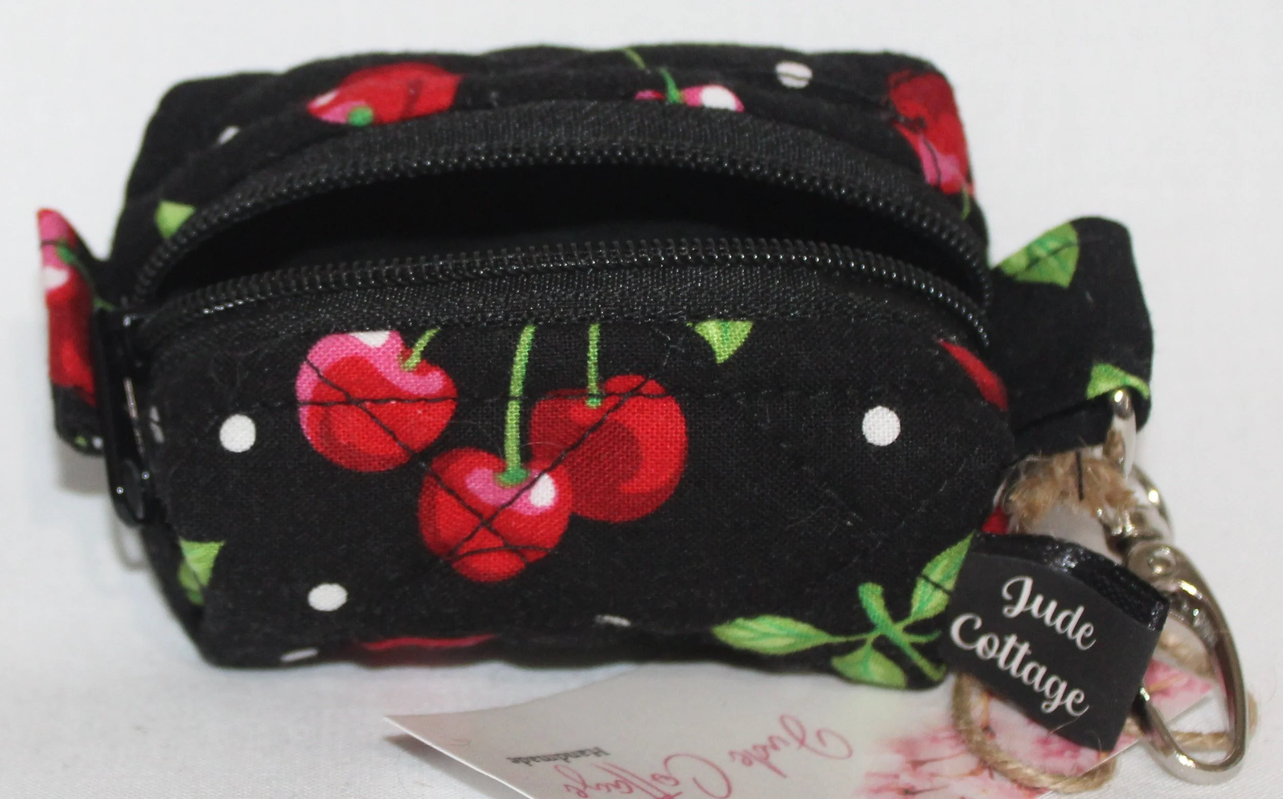 Open top view of the Scattered Cherries Bag Charm showing black lining.