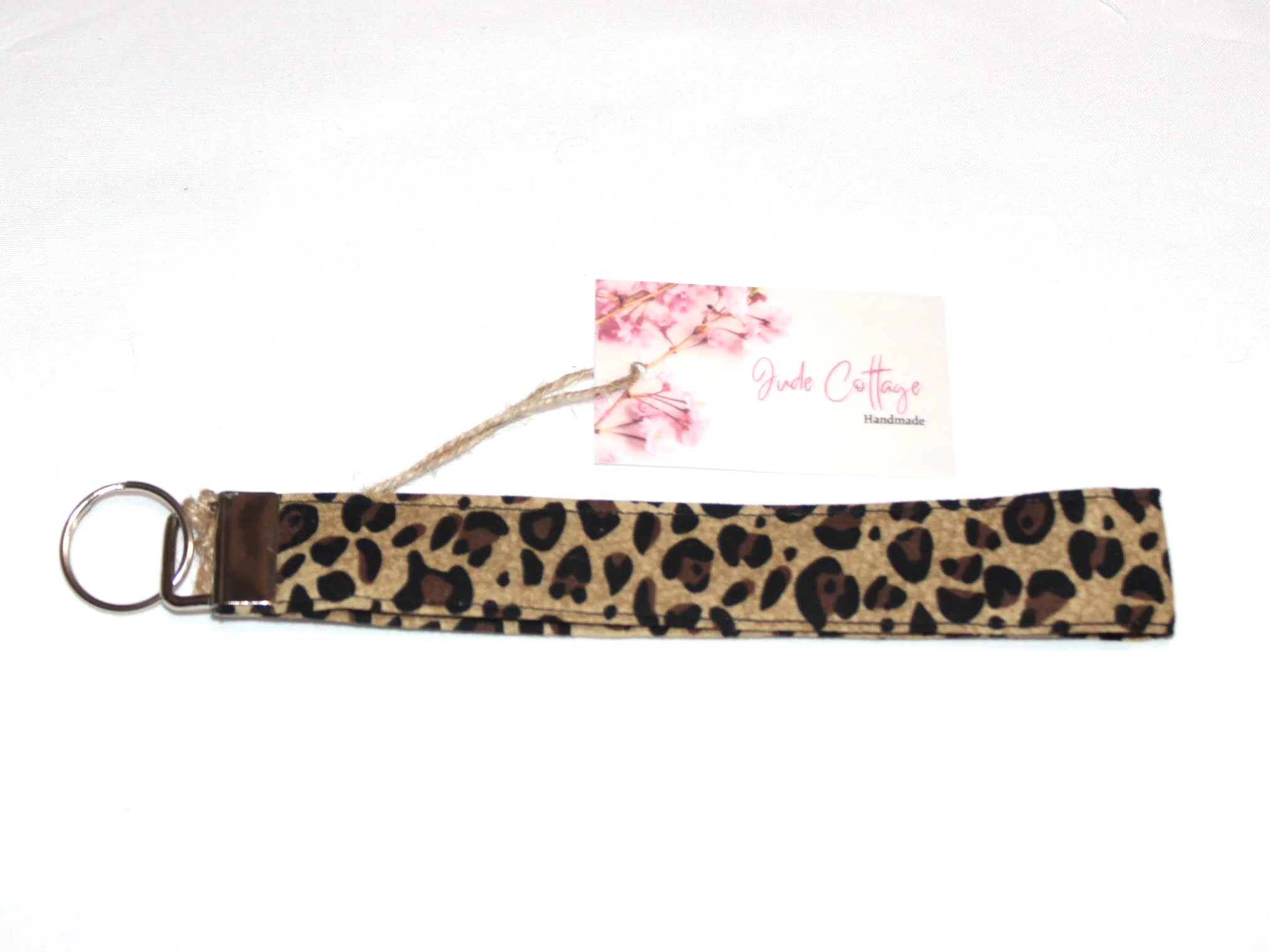 Close-up of the Sahara Wristlet featuring cheetah print and showing keyfob hardware.