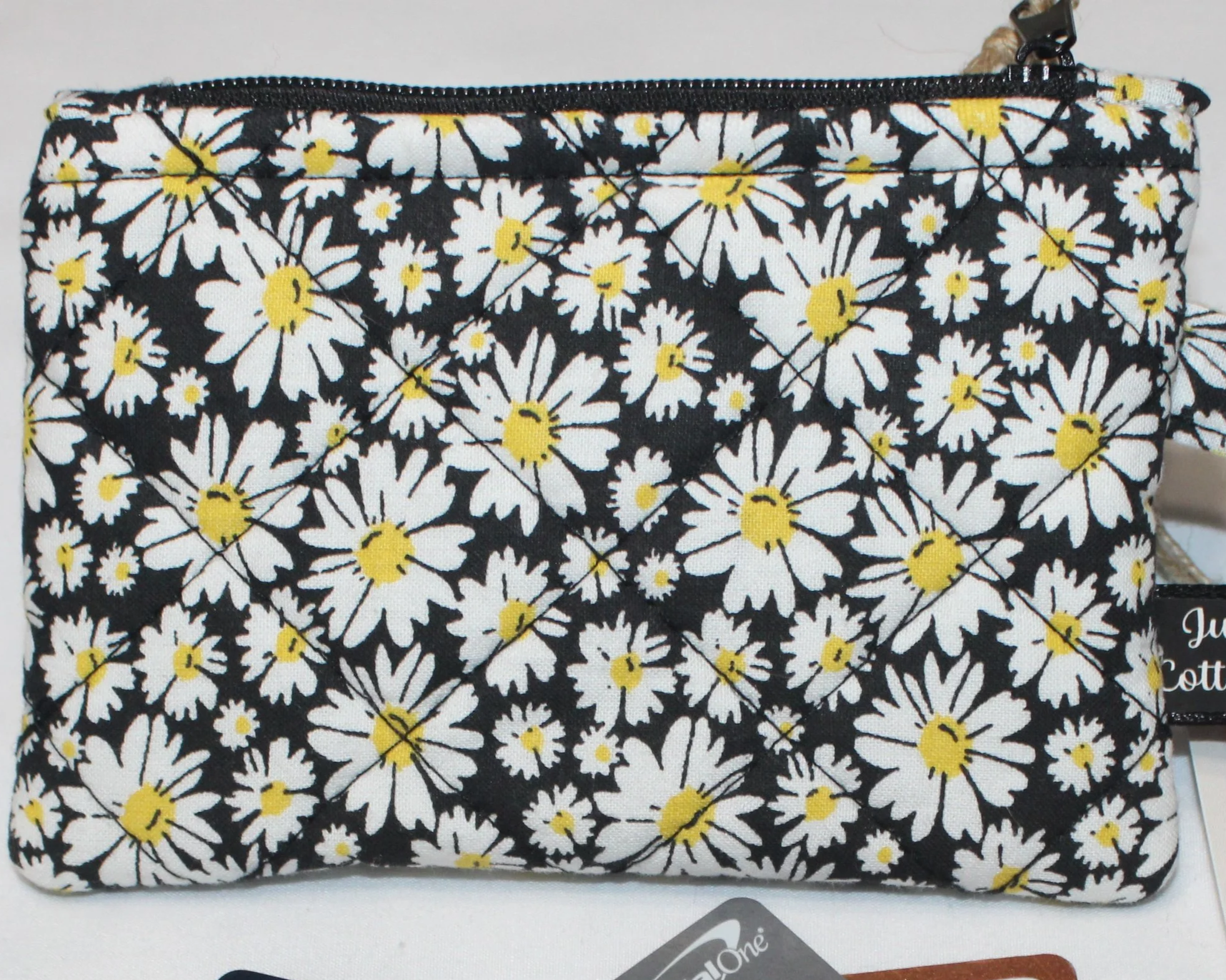 Quilted keychain wallet with small daisy pattern, zipper closure, and metal key ring.