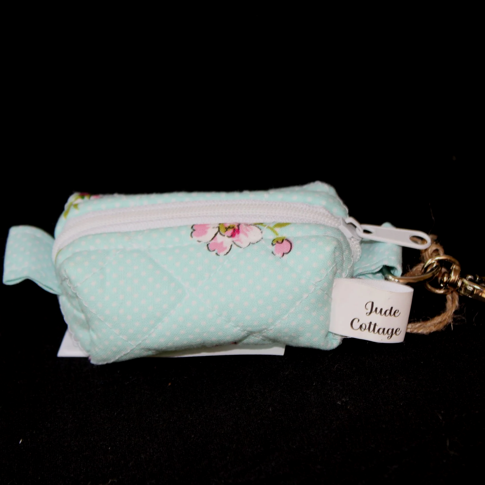 Front view of the Blossom Bag Charm featuring a light blue polka dot fabric with pink cherry blossom print.