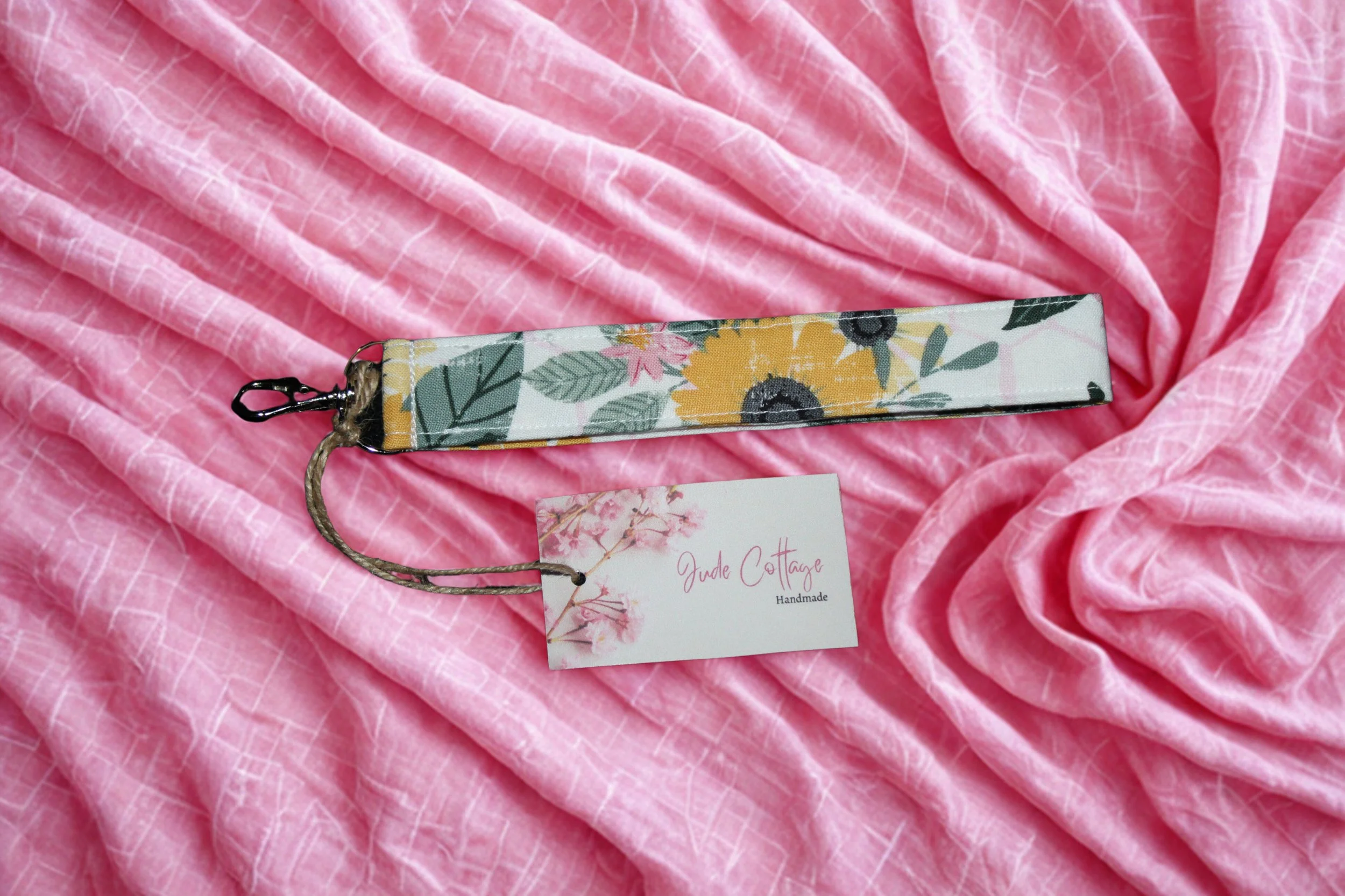Honeycomb Sunflower Wristlet shown on a pink background.