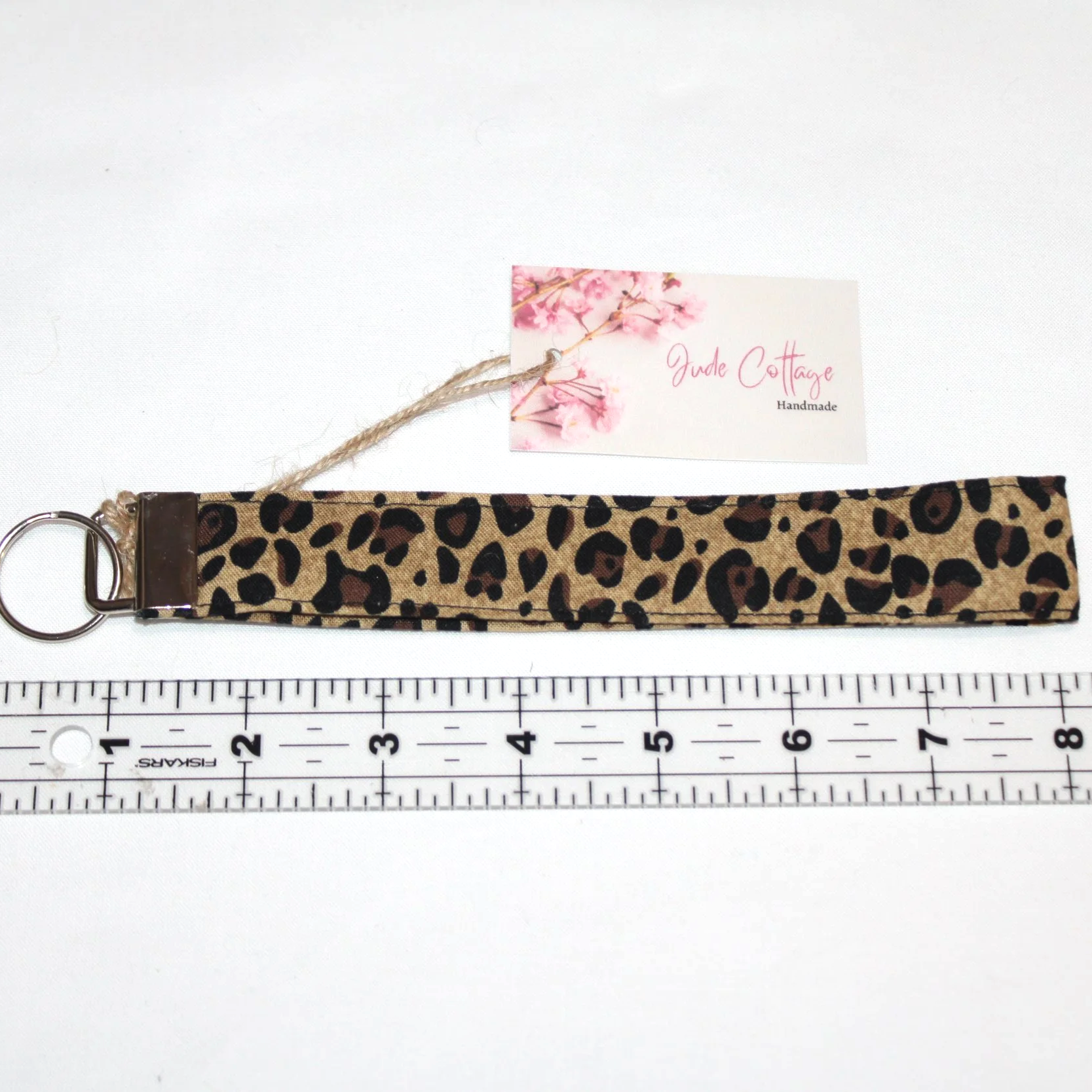 Close-up view of the Sahara Wristlet, featuring cheetah print, shown with a ruler to demonstrate size.