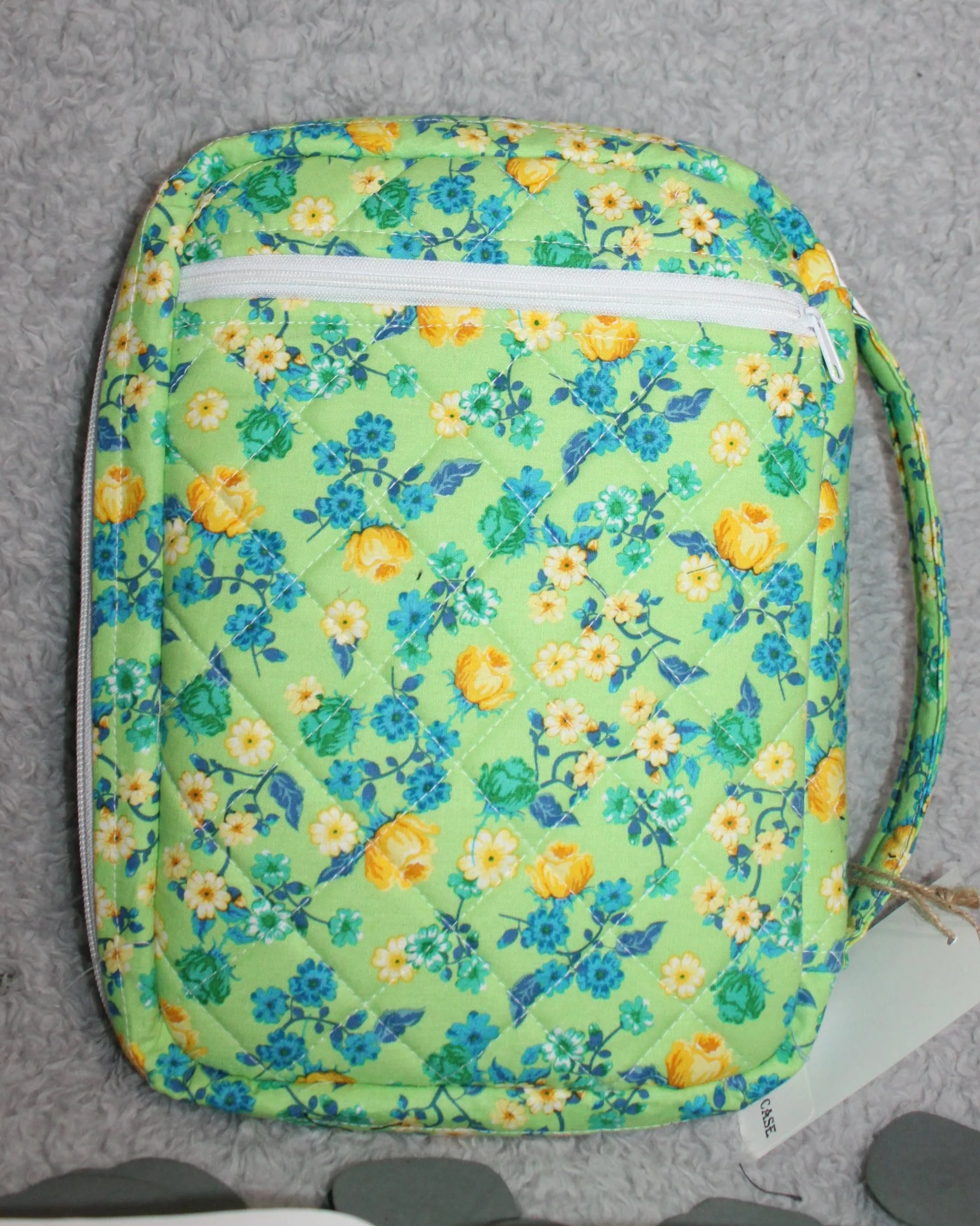 Back view of the Suzanne Bible Study Case, shown upright with the back zipper pocket and sturdy padded handle visible.