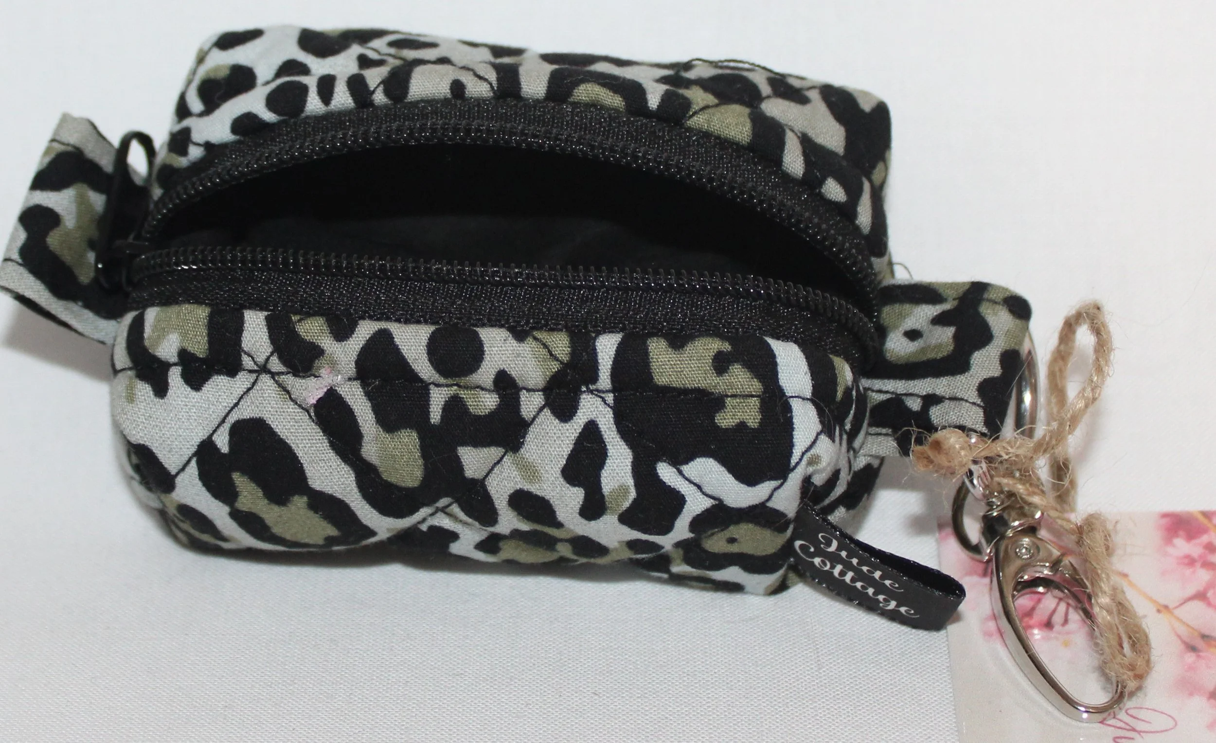 Open top view of the Diana Bag Charm featuring snow leopard print showing black lining.