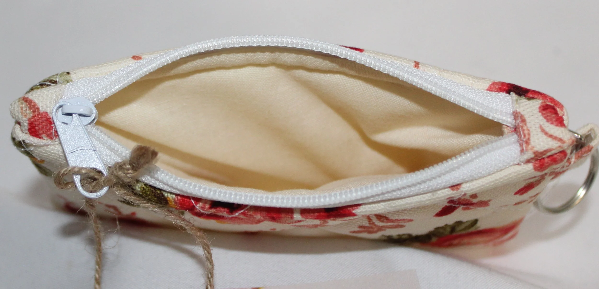 Top view quilted keychain wallet with English rose floral pattern, zipper closure, and metal key ring.