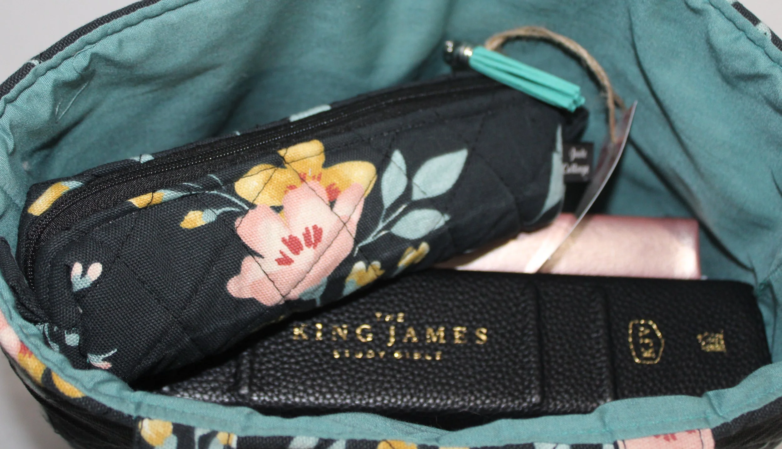 Top view of the Twyla quilted Bible sleeve with notebook, study Bible, and pencil pouch inserted illustrating size and use.