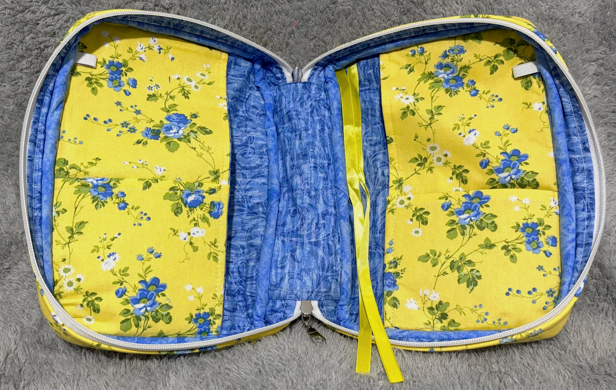 Empty interior view of the Flora Study Bible Case, showing the floral lining, interior slip pockets, and pen holders with the case fully open.