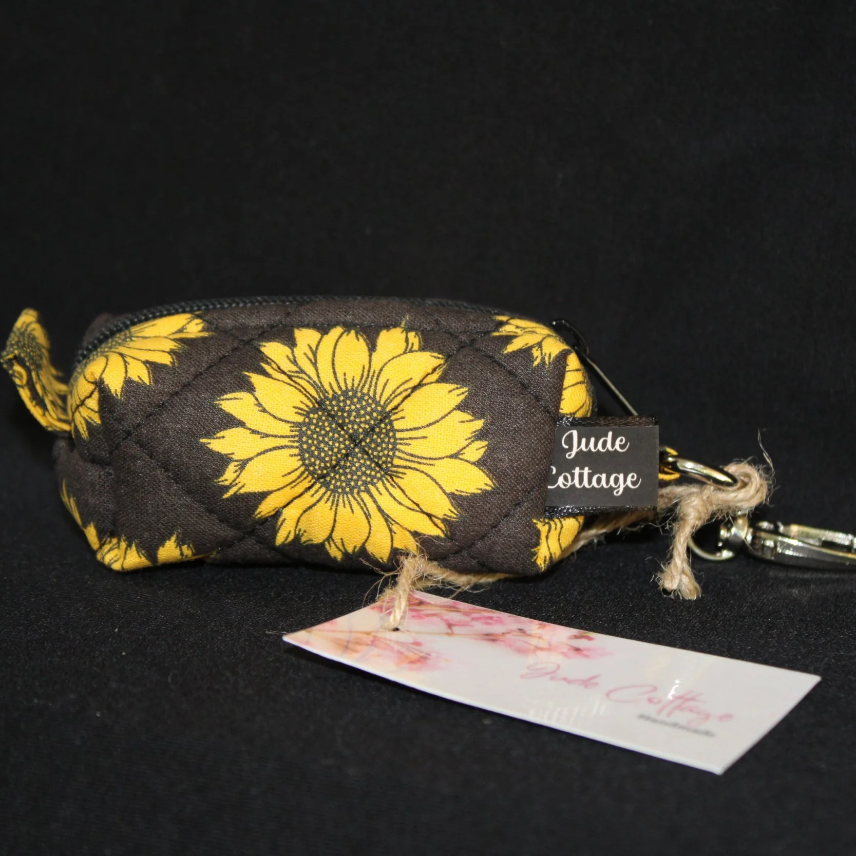 Front view of the Midnight Sunflower Bag Charm featuring a black background fabric with bright golden yellow sunflowers.