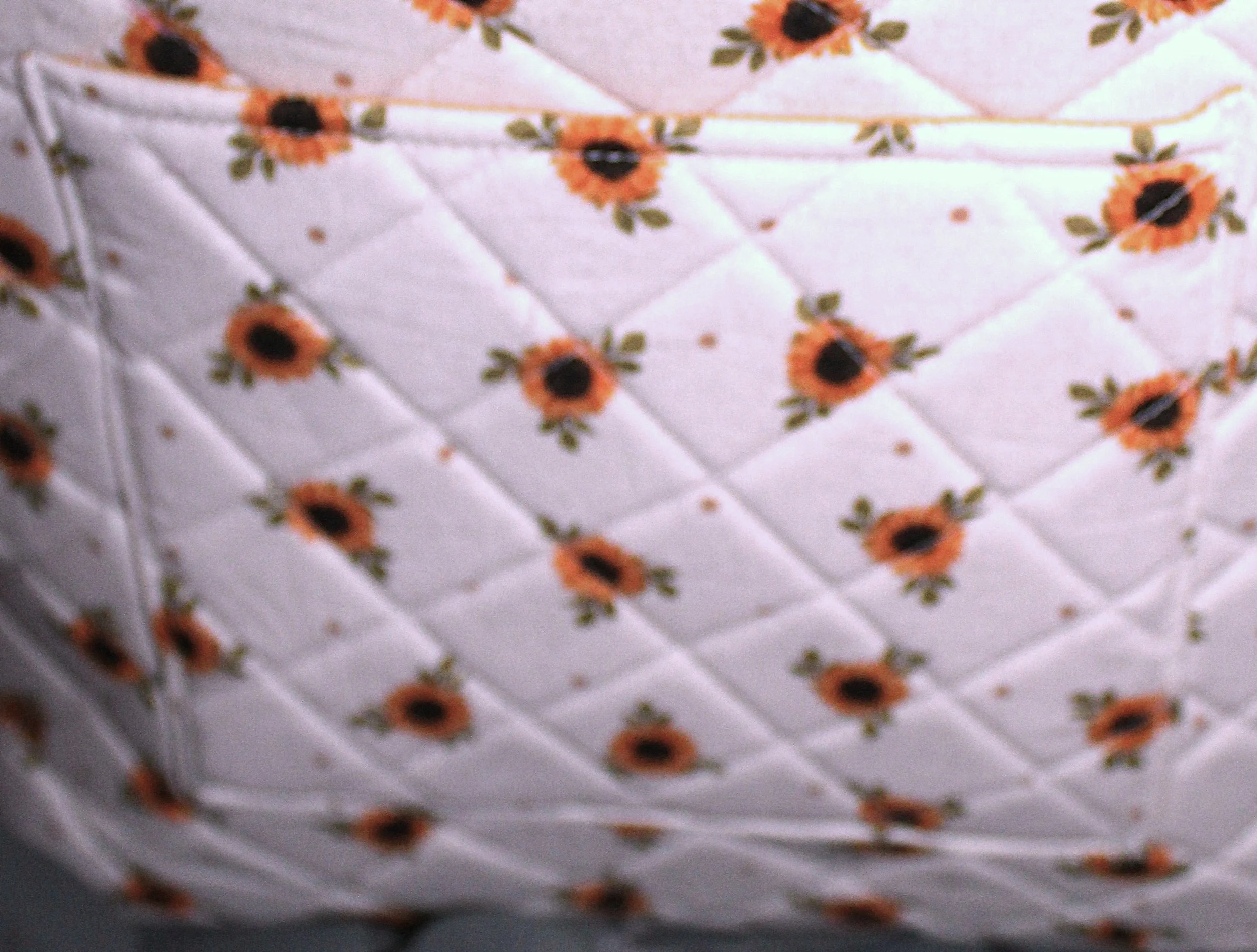 Up‑close view of the back slip pocket of the Sunflower Medley quilted tote, showing the quilted pattern.