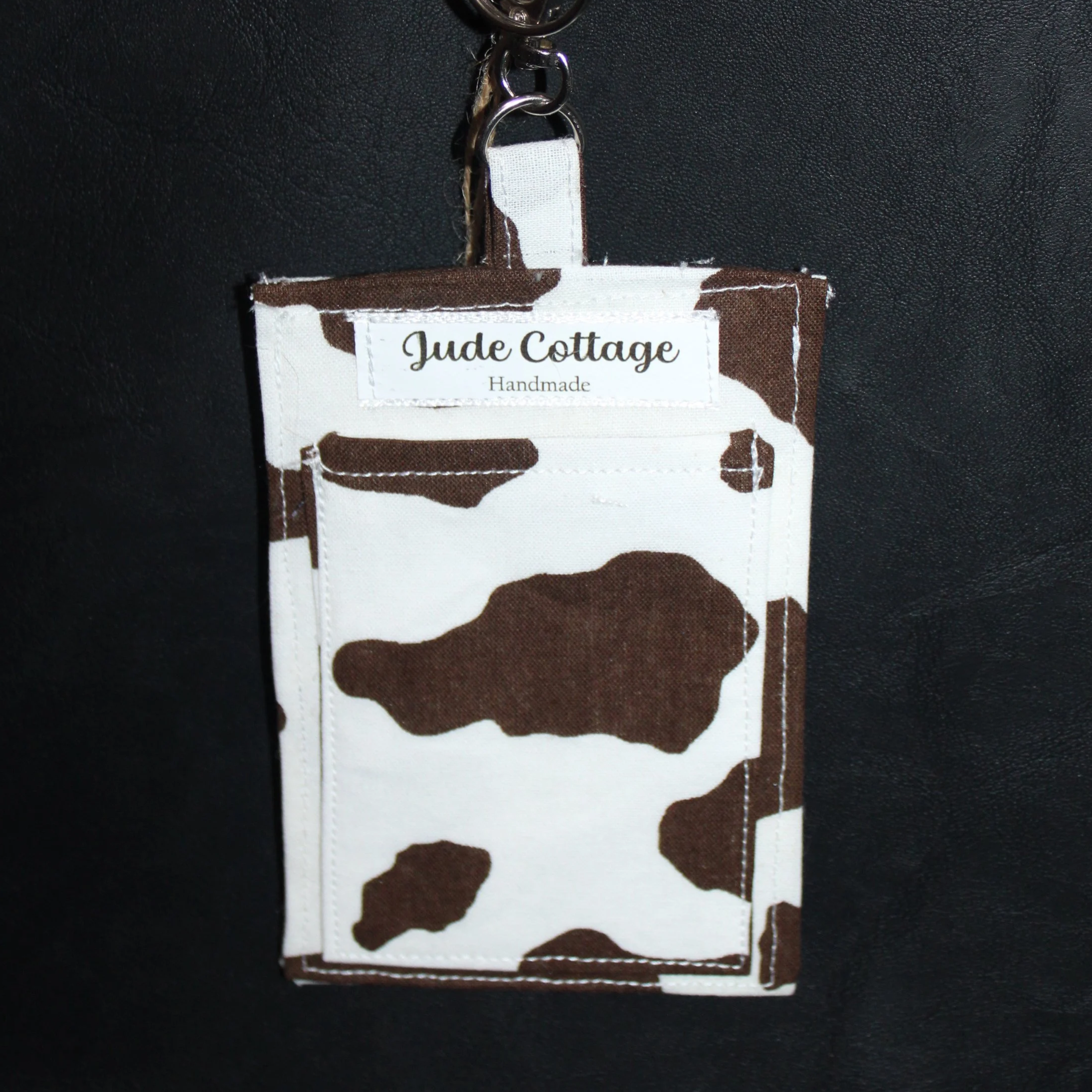 Empty back view of the Brown Cow Badge Holder featuring a slip pocket for carrying cards, cash, or other essentials.