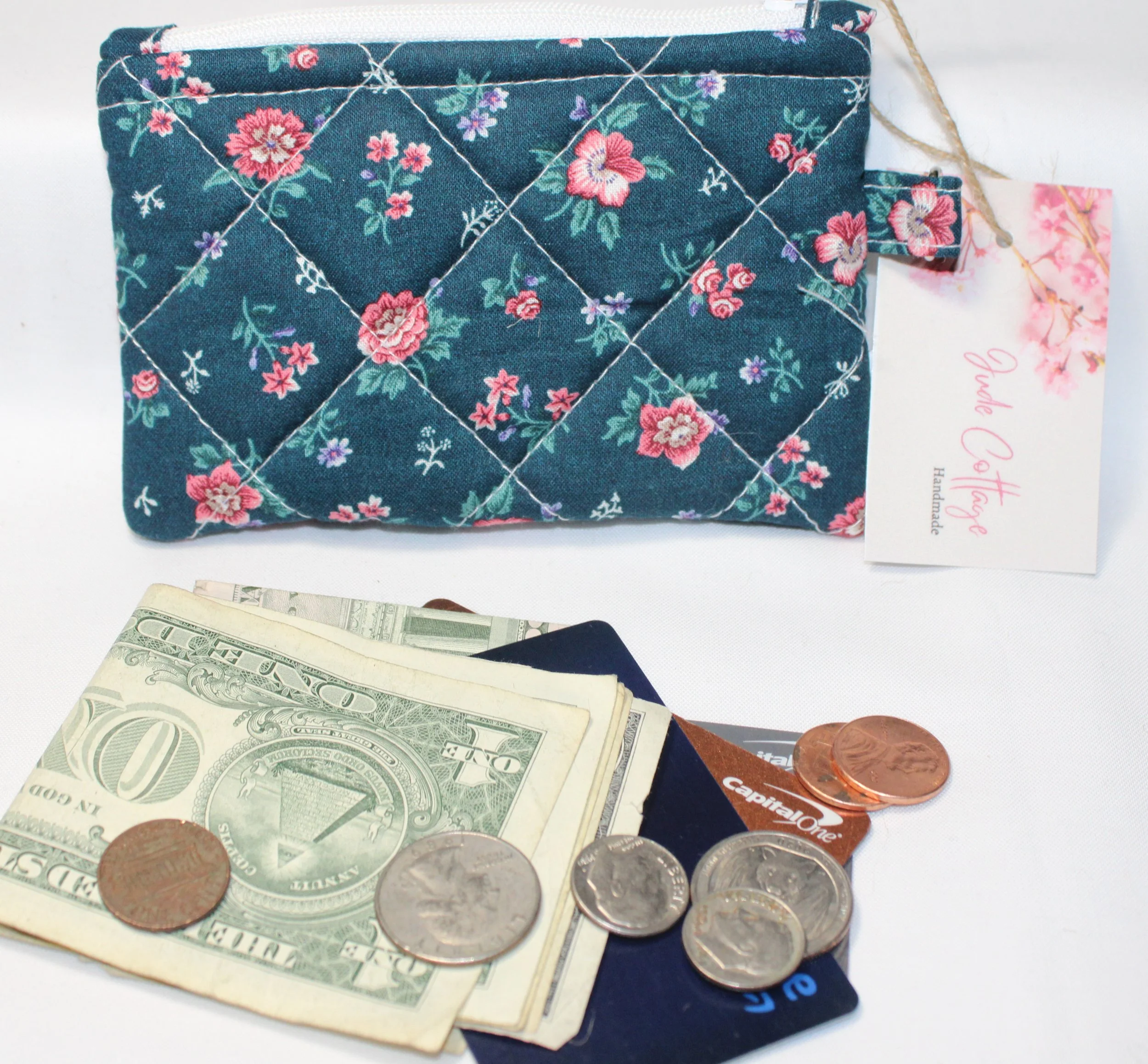 Quilted keychain wallet with Eliza pattern, zipper closure, and metal key ring.