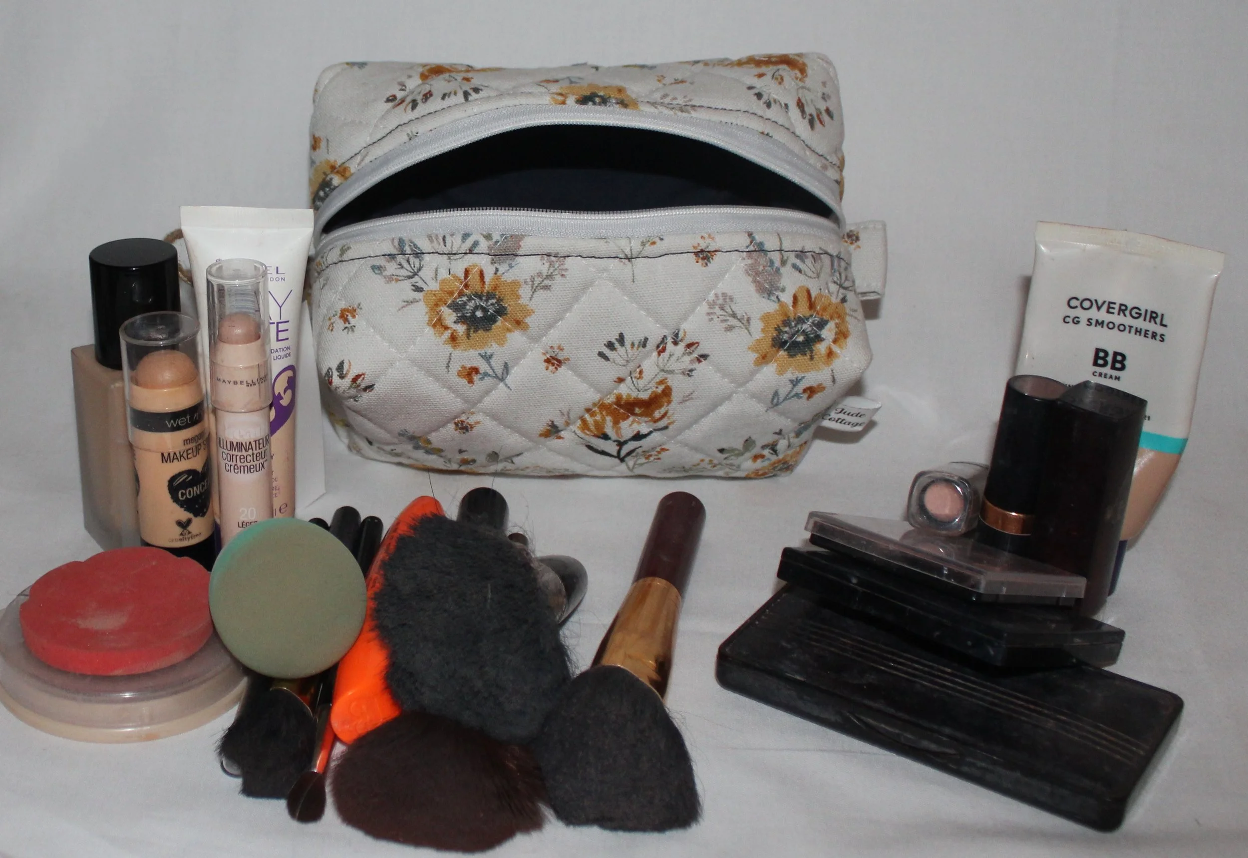 Top view of the open small Dandelion Blue floral quilted travel pouch with the empty interior visible.