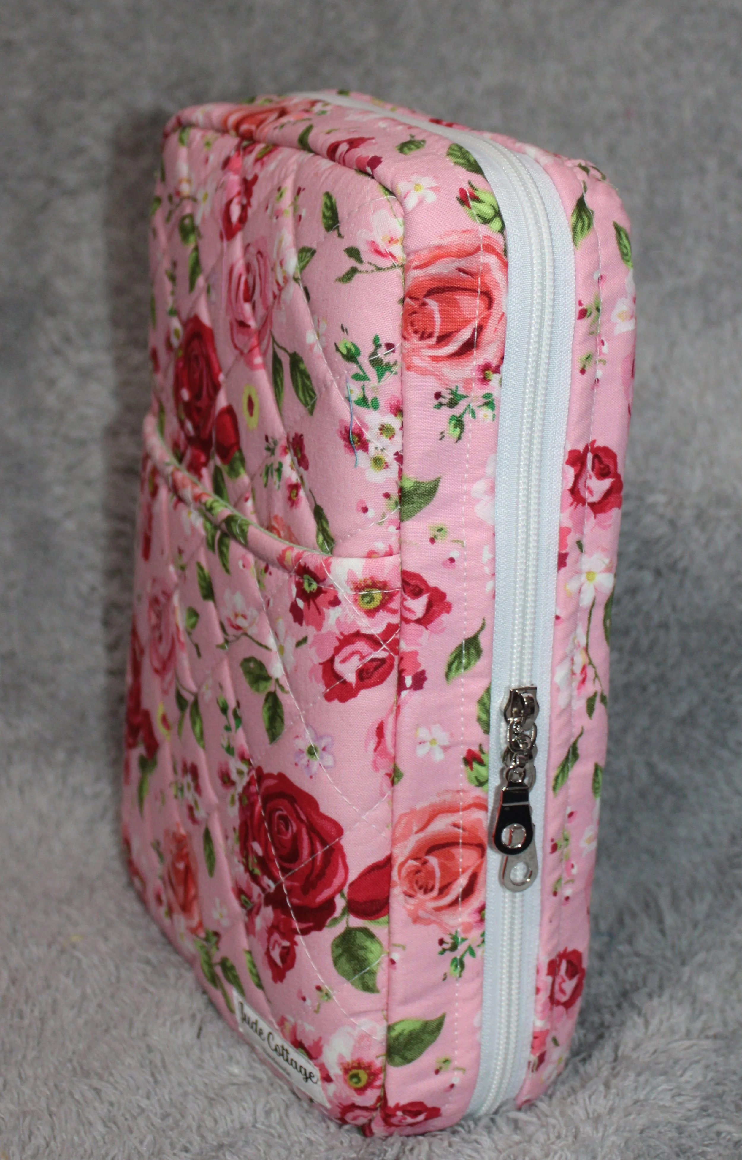 Side view of the Roselyn pink quilted double-zip Bible case showing the double zip.